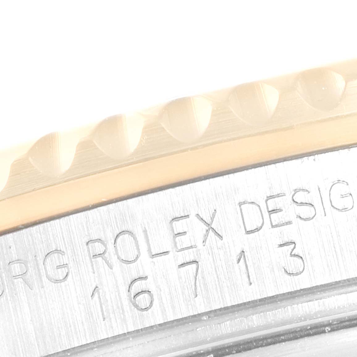 The image shows a close-up of the side casing and serial number of a Rolex GMT-Master 16713 Men's Steel and Gold (two tone) Black Dial 16713 Men's Steel and Gold (two tone) Black Dial model.
