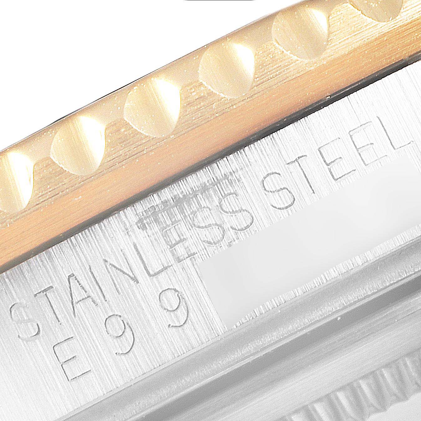 This close-up shows the bezel and case with "STAINLESS STEEL" engraved on a Rolex GMT-Master 16713 Men's Steel and Gold (two tone) Black Dial 16713 Men's Steel and Gold (two tone) Black Dial watch.