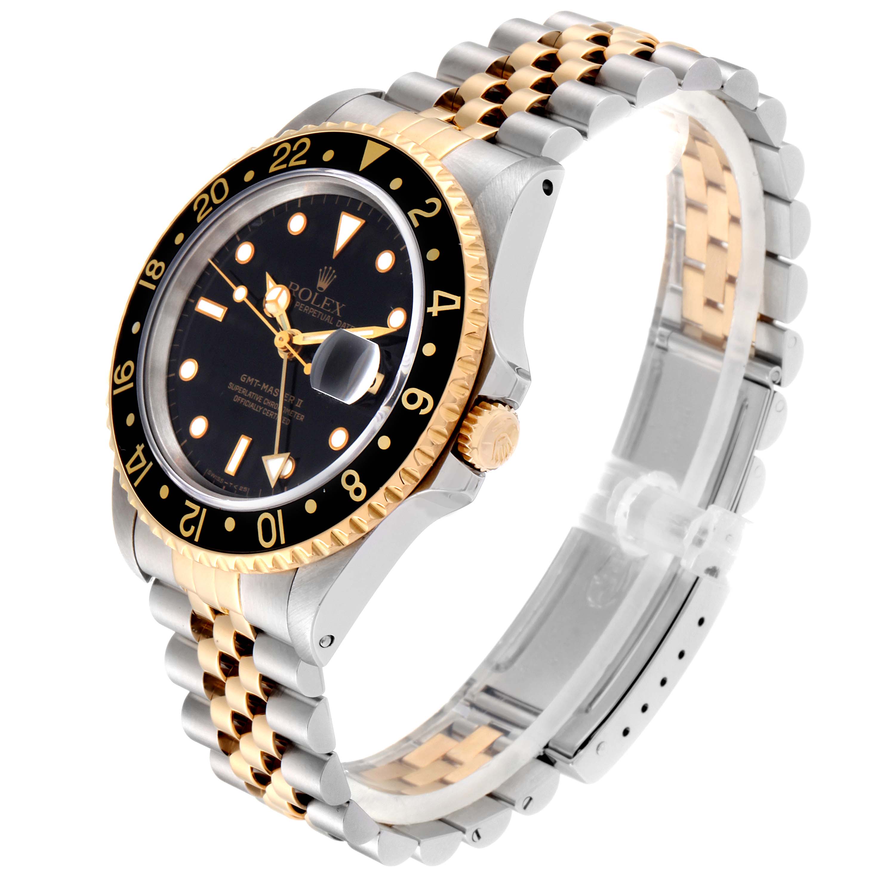 This Rolex GMT-Master 16713 Men's Steel and Gold (two tone) Black Dial 16713 Men's Steel and Gold (two tone) Black Dial watch is shown at an angled side view, highlighting its bezel, dial, case, crown, and two-tone bracelet.