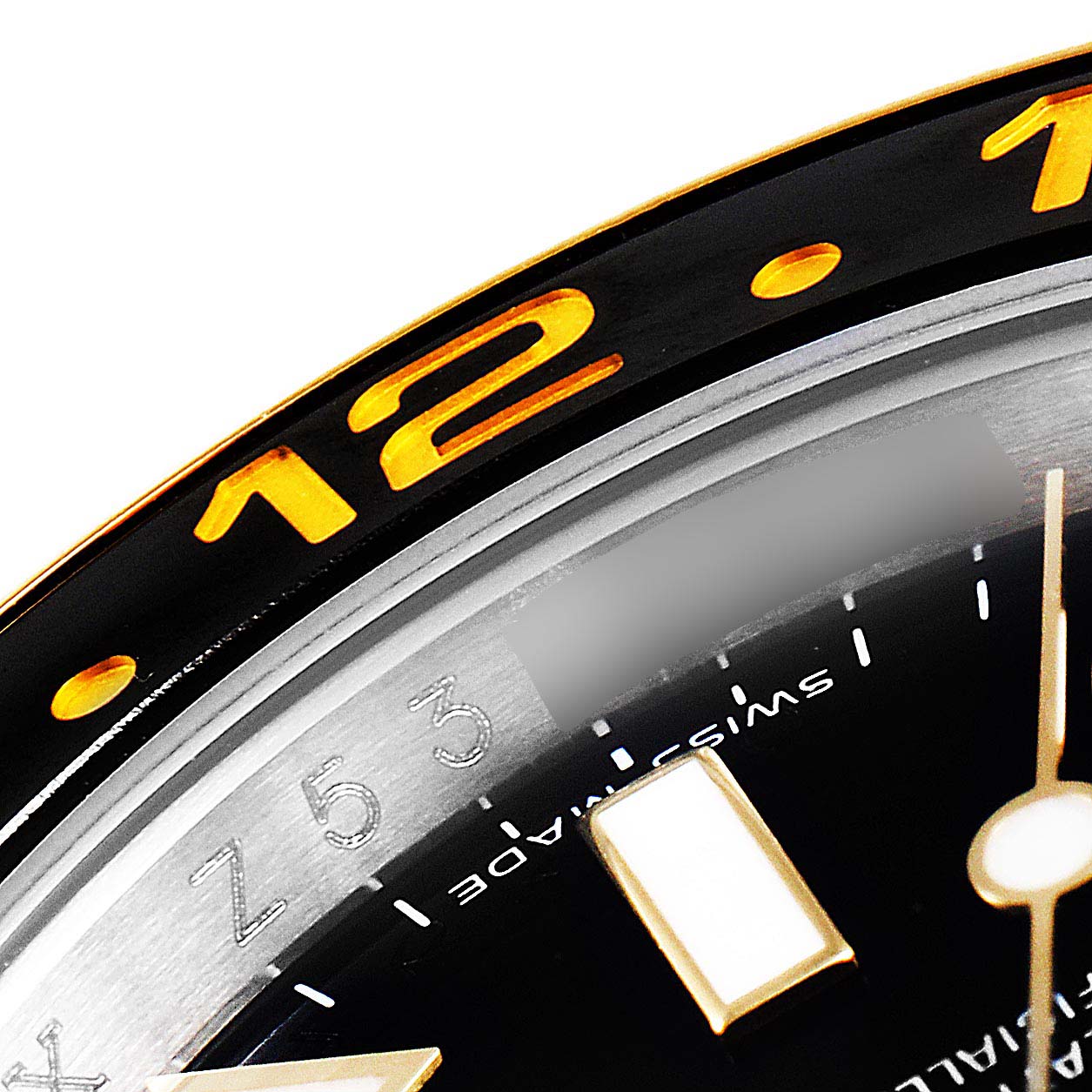 The close-up image shows a partial view of the bezel and dial of a Rolex GMT-Master 116713 Men's Steel and Gold (two tone) Black Dial 116713 Men's Steel and Gold (two tone) Black Dial watch.