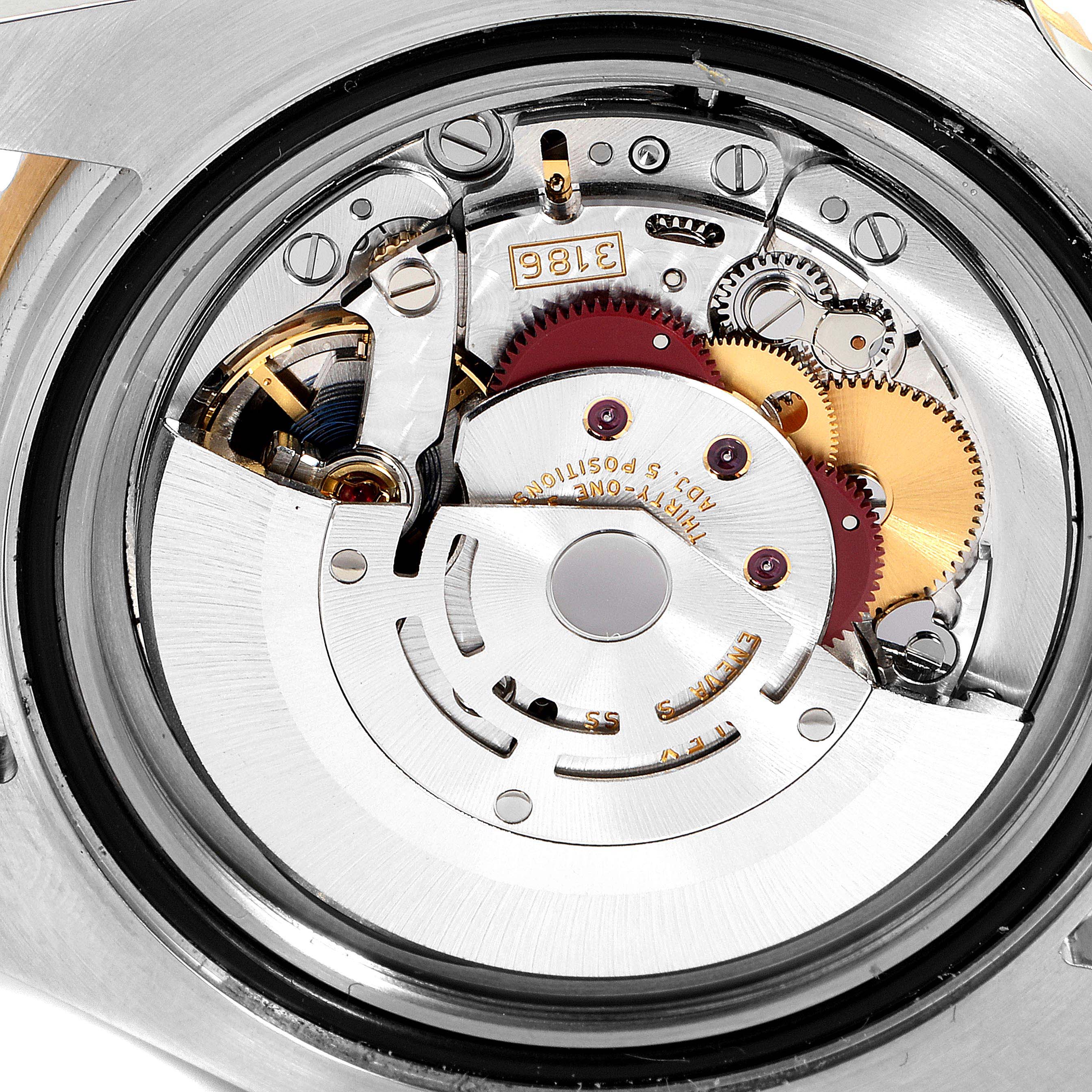 This image shows the internal mechanism of the Rolex GMT-Master 116713 Men's Steel and Gold (two tone) Black Dial 116713 Men's Steel and Gold (two tone) Black Dial watch from a back angle, featuring gears and the movement components.