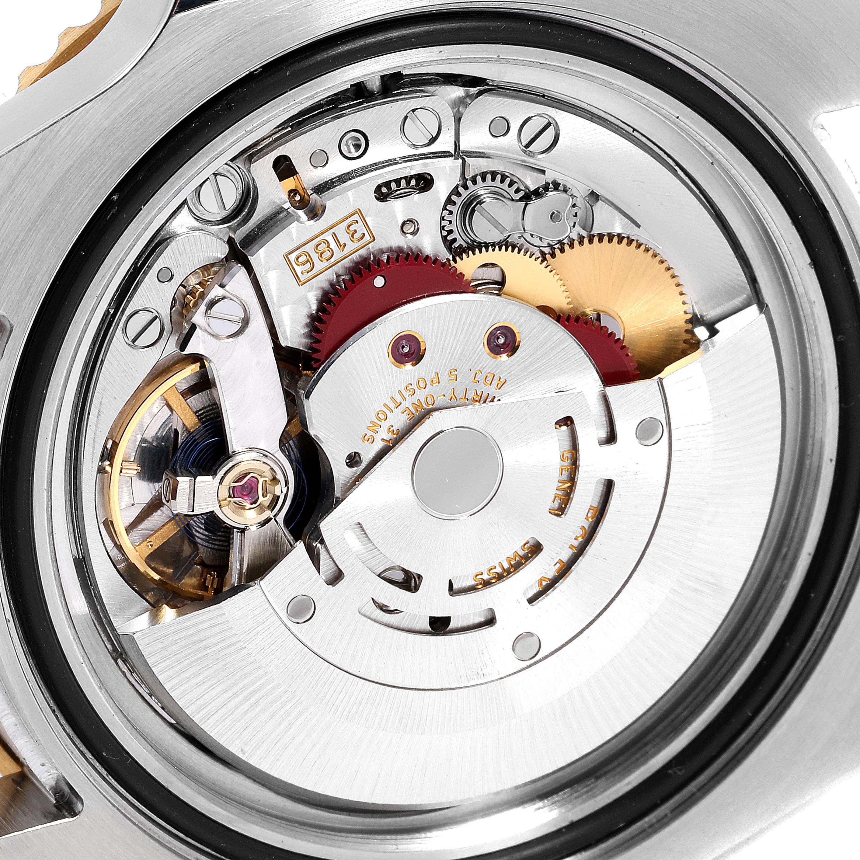 This is a close-up view of the Rolex GMT-Master 116713 Men's Steel and Gold (two tone) Black Dial 116713 Men's Steel and Gold (two tone) Black Dial watch's internal movement mechanism.