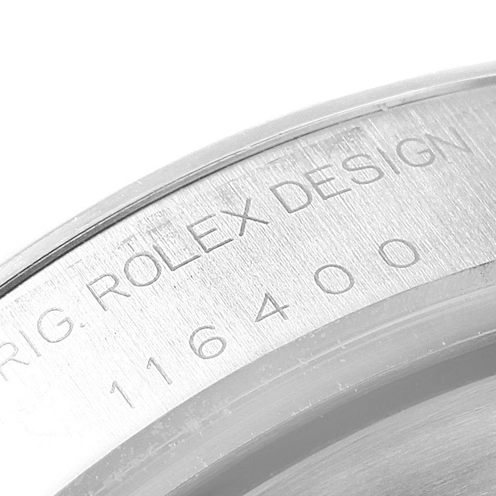 The image shows a close-up of the model number 116400 and "ROLEX DESIGN" engraving on a Rolex Milgauss 116400GV Men's Stainless Steel Black Dial 116400GV Men's Stainless Steel Black Dial watch component.