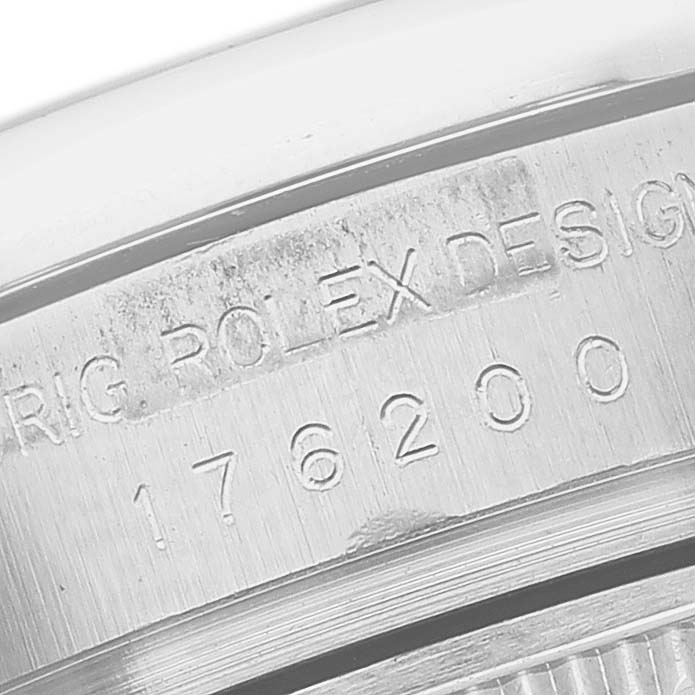 The image shows a close-up of the engraving on the side of a Rolex Oyster Perpetual 176200 Women's Stainless Steel Silver Dial watch case.