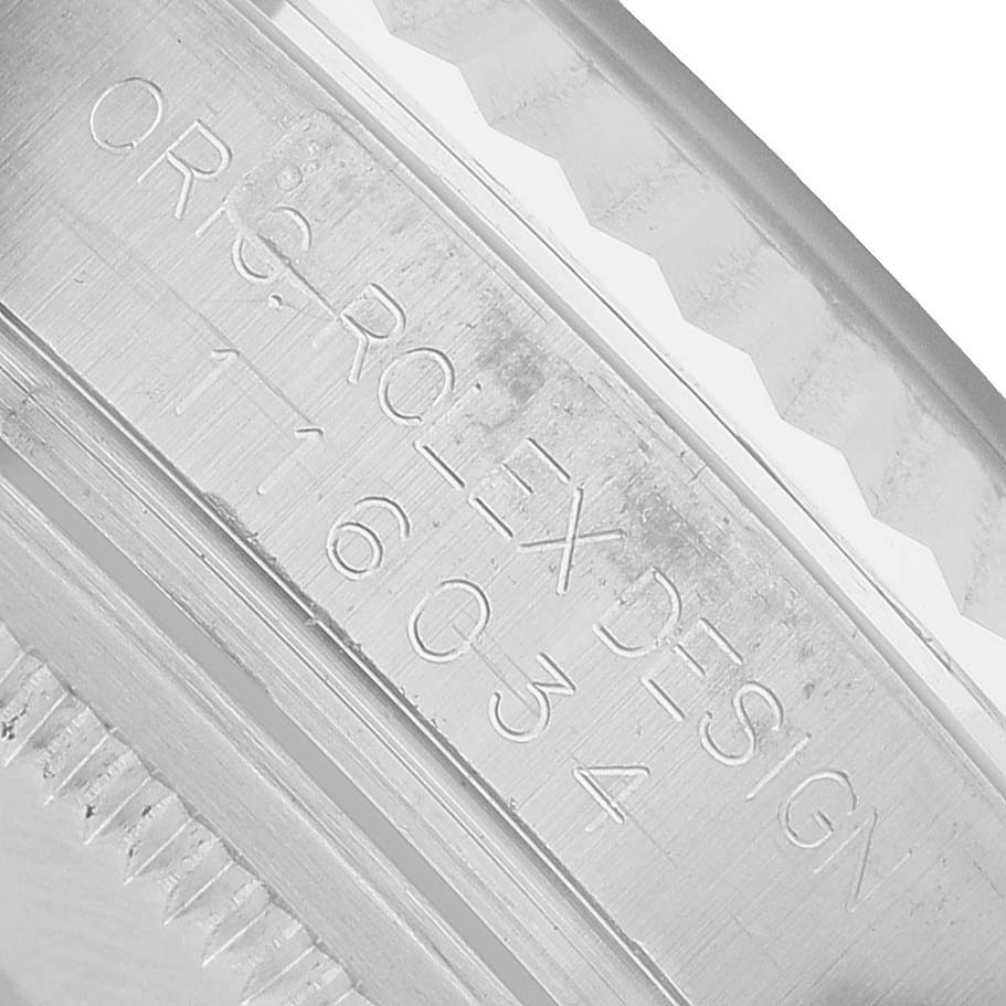 The image shows a close-up of the engraving on the side of a Rolex Oyster Perpetual 116034 Men's Stainless Steel Blue Dial watch case.