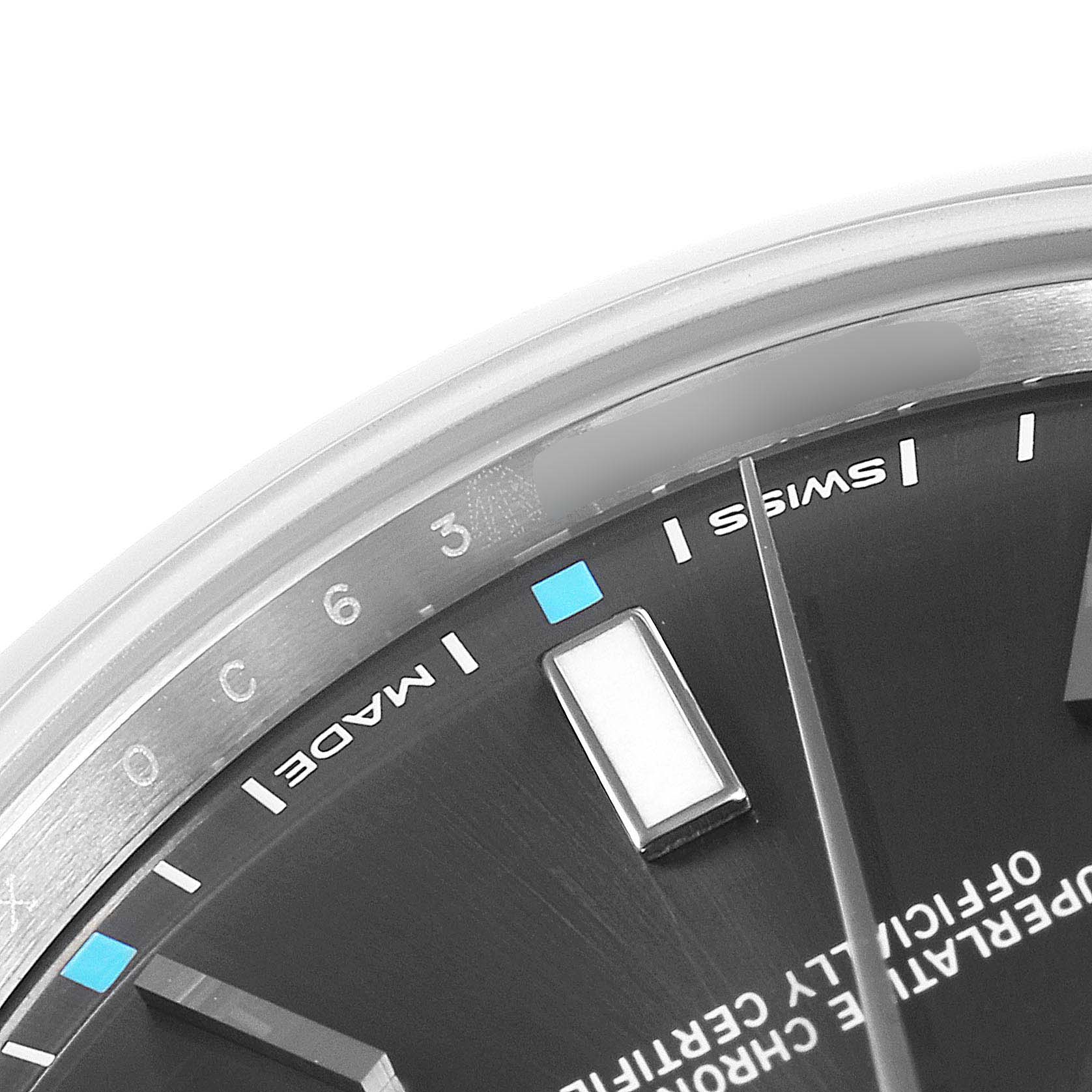 This image shows a close-up of the dial and bezel of a Rolex Oyster Perpetual 114300 Men's Stainless Steel Silver Dial 114300 Men's Stainless Steel Silver Dial watch.