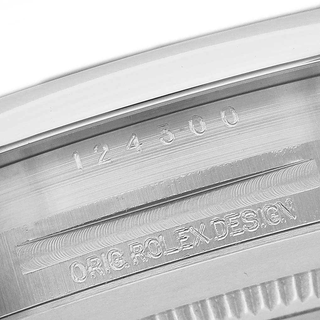 The image shows the side profile of a Rolex Oyster Perpetual 124300 Men's Stainless Steel Green Dial watch's case with engraved model and design details.