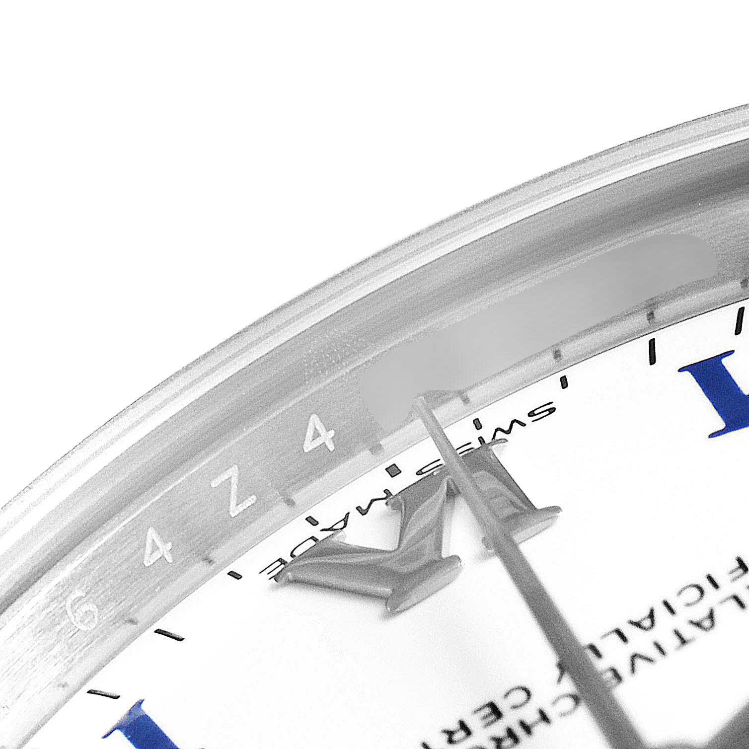 This close-up image shows the dial and bezel of a Mid-Size Rolex watch, highlighting the markers and part of the second hand.
