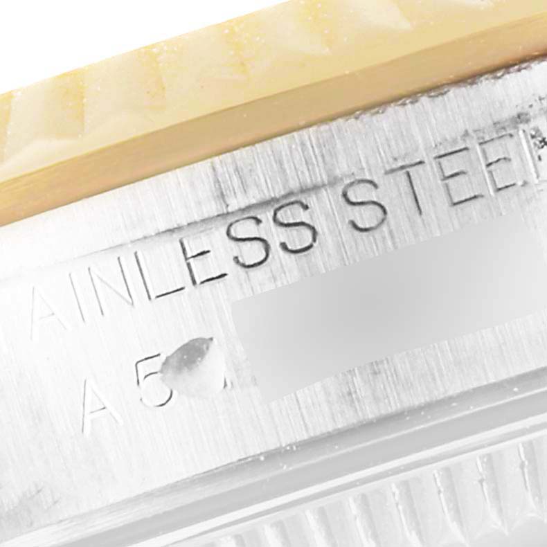 This image shows a close-up of the side engraving on a Rolex Oyster Perpetual 76193 Women's Steel and Gold (two tone) Champagne Dial 76193 Women's Steel and Gold (two tone) Champagne Dial watch, highlighting "STAINLESS STEEL."