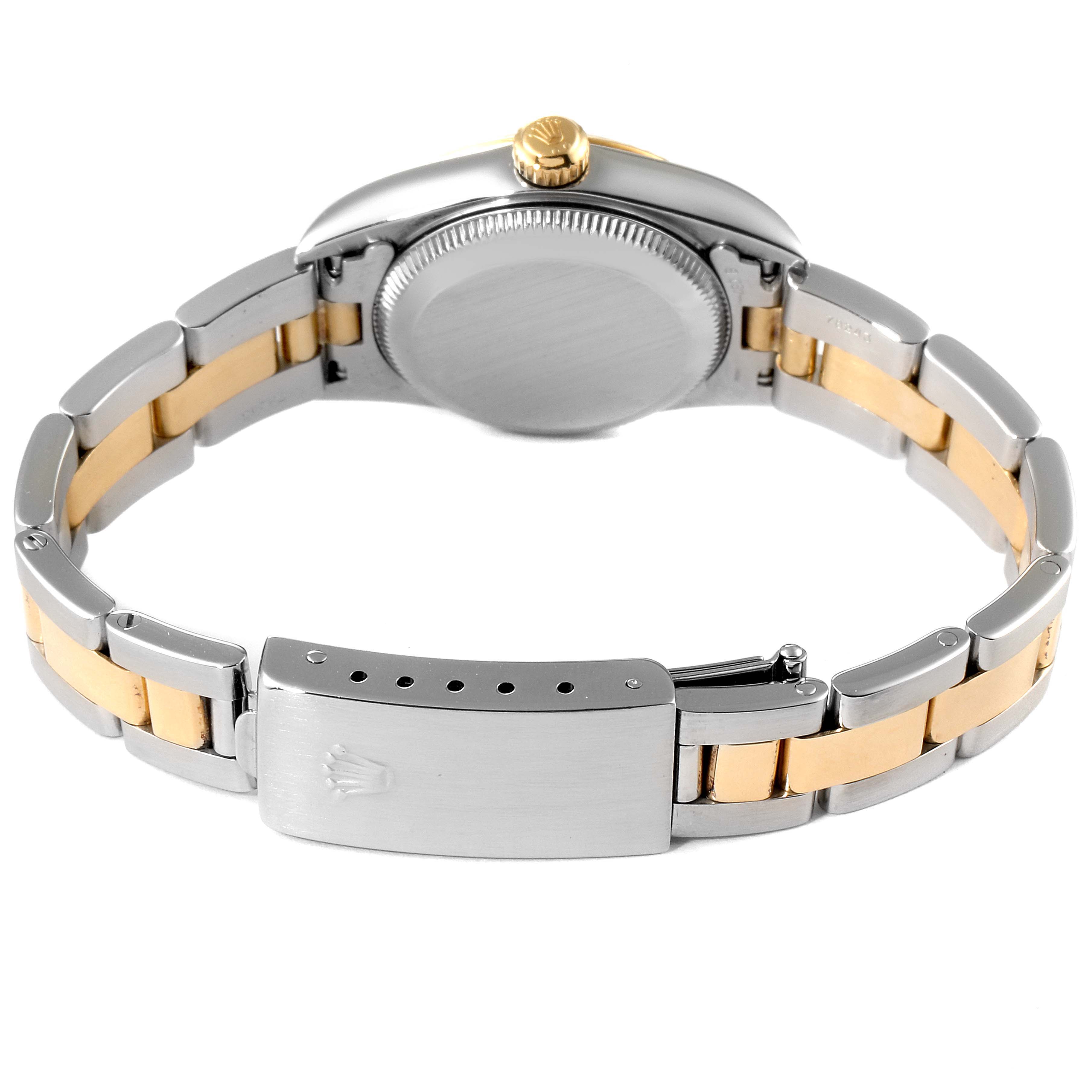 The image shows the back view of a Rolex Oyster Perpetual 76193 Women's Steel and Gold (two tone) Champagne Dial 76193 Women's Steel and Gold (two tone) Champagne Dial watch, highlighting the case back and two-tone bracelet.