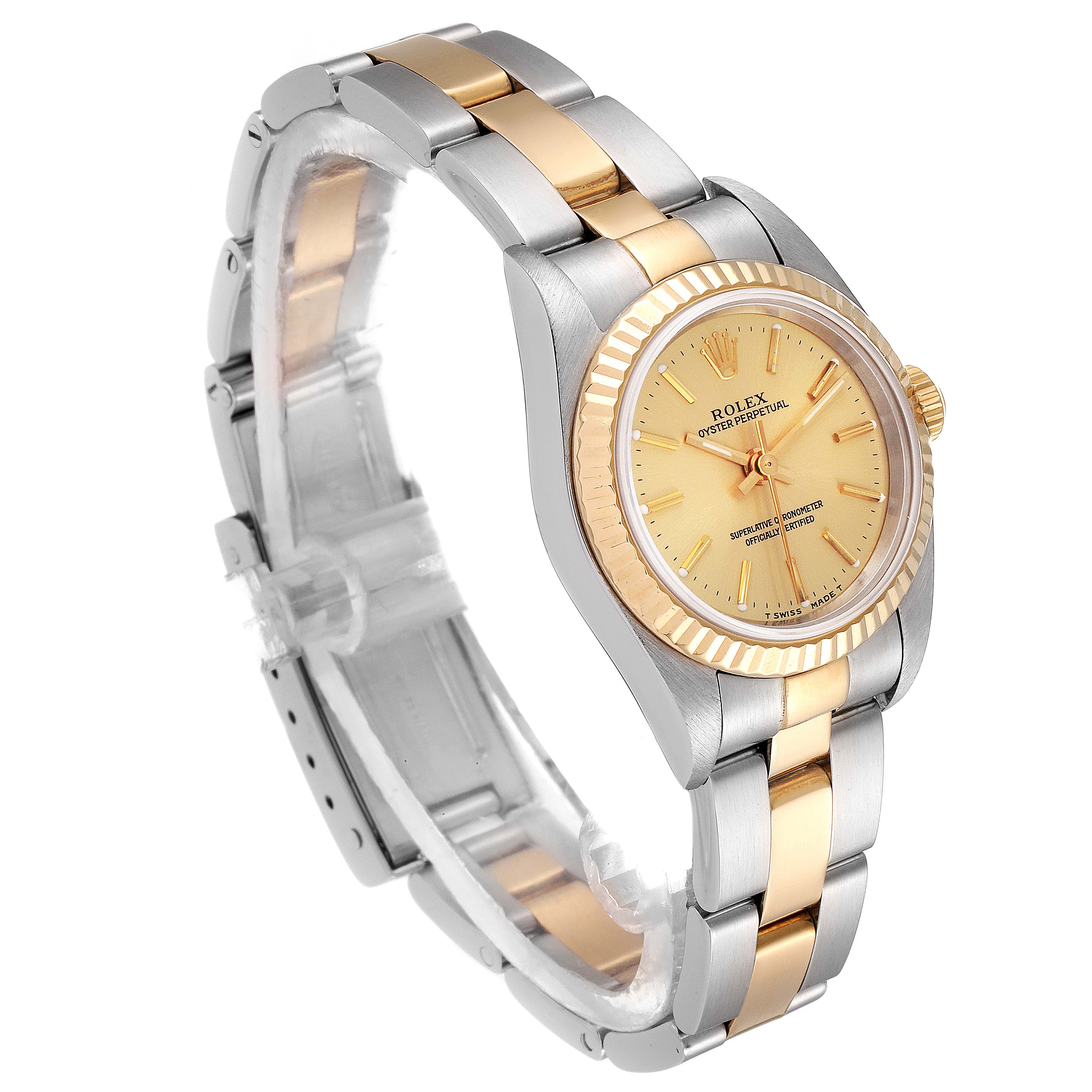This image shows a Rolex Oyster Perpetual 76193 Women's Steel and Gold (two tone) Champagne Dial 76193 Women's Steel and Gold (two tone) Champagne Dial watch at an angle highlighting its face and two-tone metal bracelet.