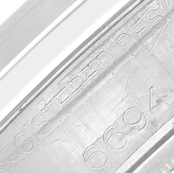 The image shows a close-up view of the inner case of a Rolex Vintage Collection 6694 Men's Stainless Steel Silver Dial 6694 Men's Stainless Steel Silver Dial model, highlighting engraved serial numbers and text.