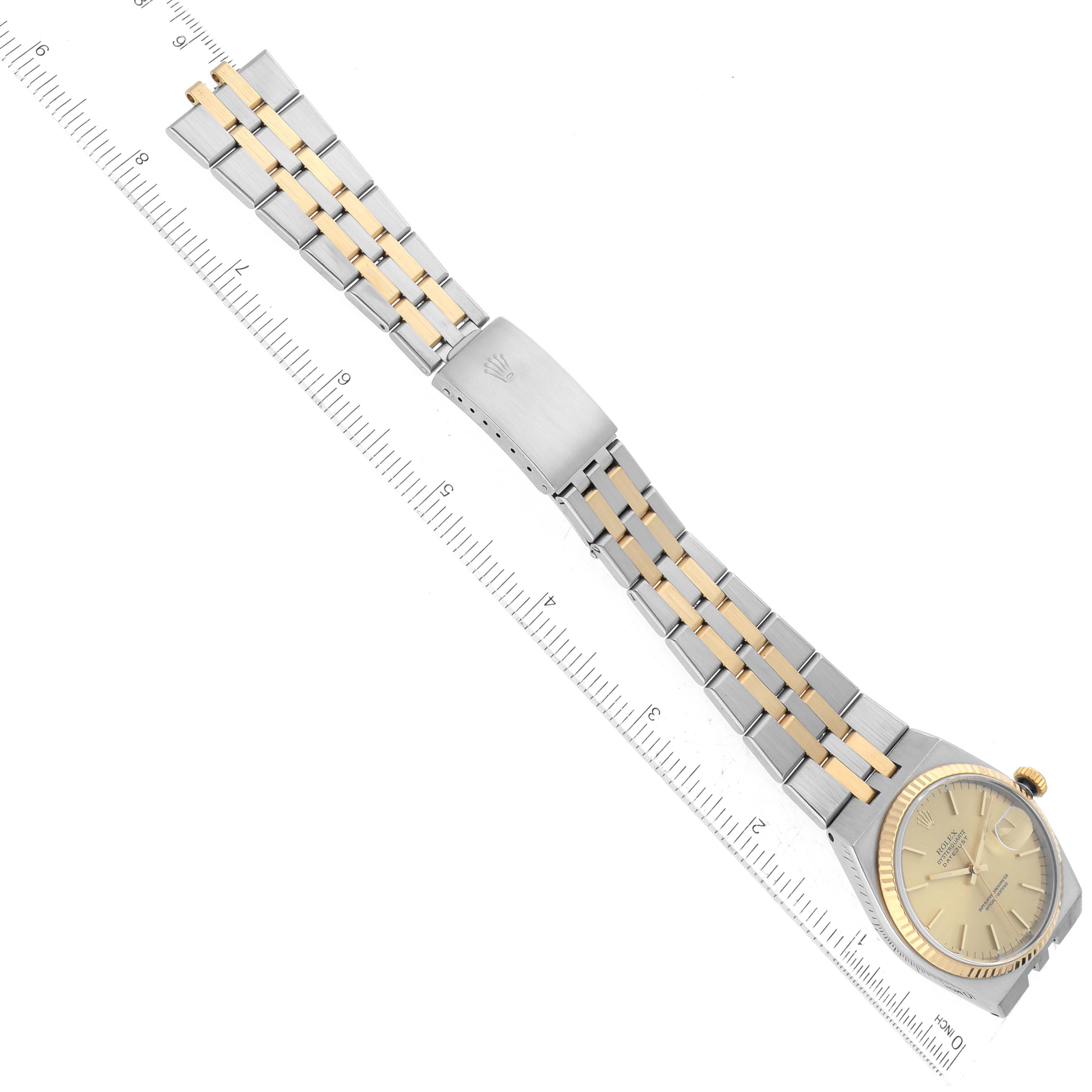 A Rolex Oysterquartz 17013 Men's Steel and Gold (two tone) Champagne Dial 17013 Men's Steel and Gold (two tone) Champagne Dial watch is shown at a diagonal angle, revealing the bracelet, clasp, and face of the watch.