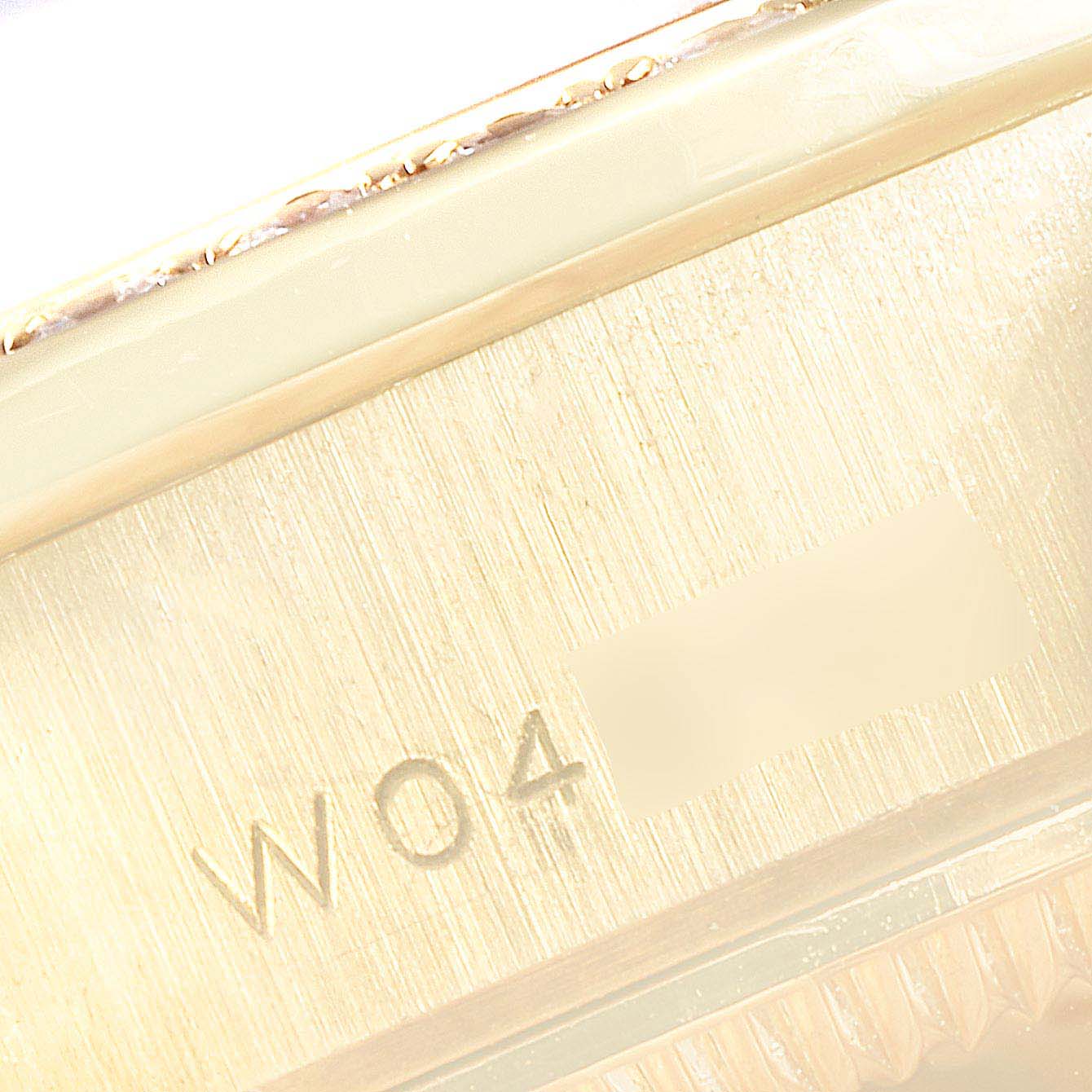 The image shows a close-up of the serial number engraved on the side of a Rolex President 69158 Women
s Yellow Gold Champagne Dial 69158 Women
s Yellow Gold Champagne Dial model watch.