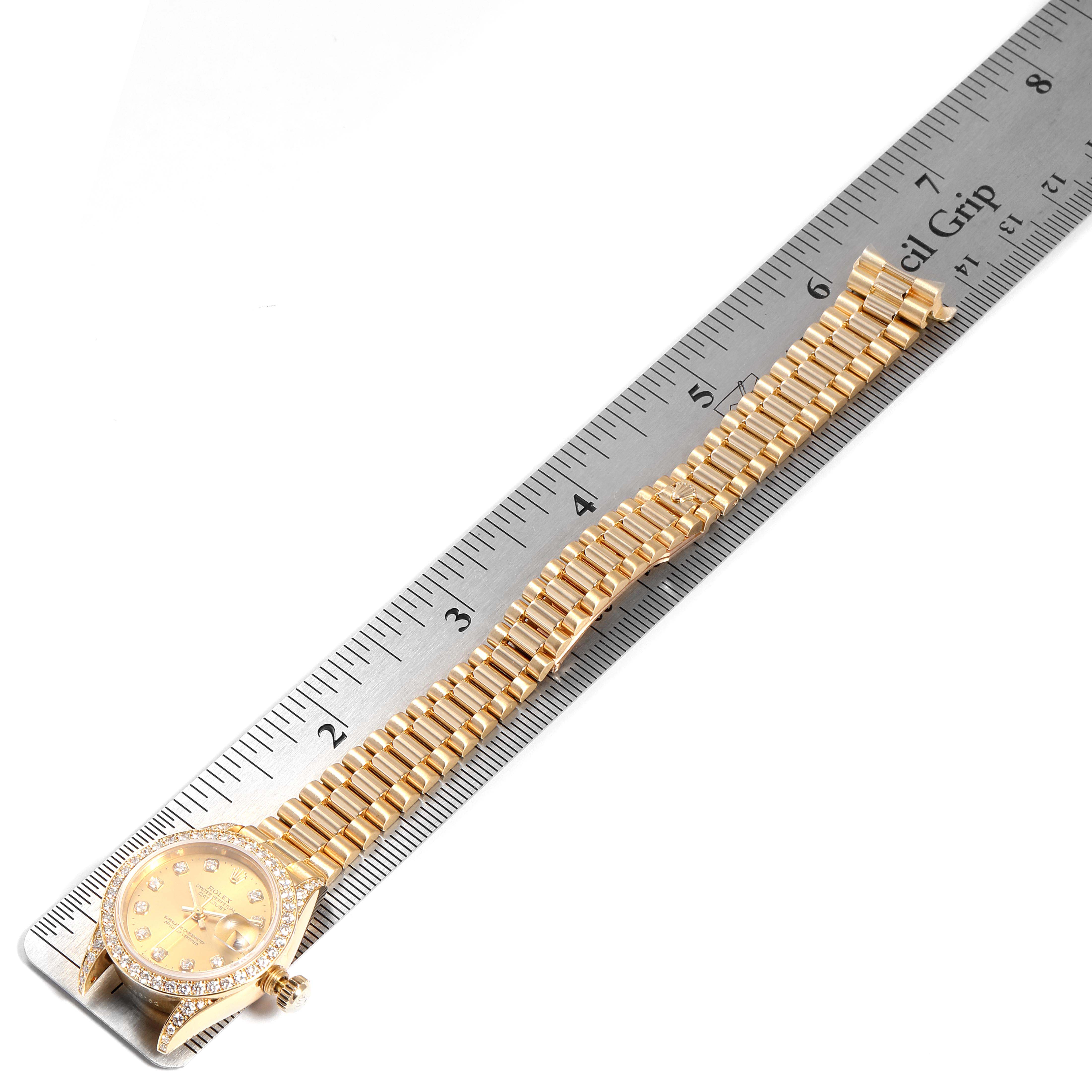The Rolex President 69158 Women
s Yellow Gold Champagne Dial 69158 Women
s Yellow Gold Champagne Dial model watch is shown from an angled top view, including the dial and the full bracelet, placed alongside a ruler.