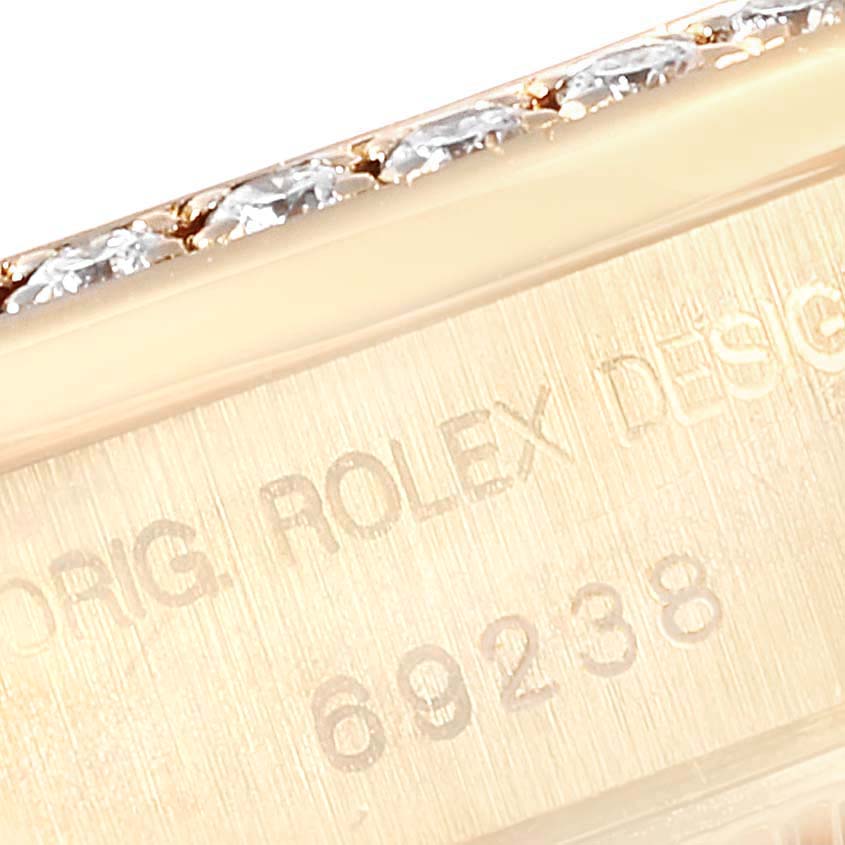 This close-up image shows the side of a Rolex President 69238 Women's Yellow Gold Silver Dial 69238 Women's Yellow Gold Silver Dial model watch case with part of its serial number.