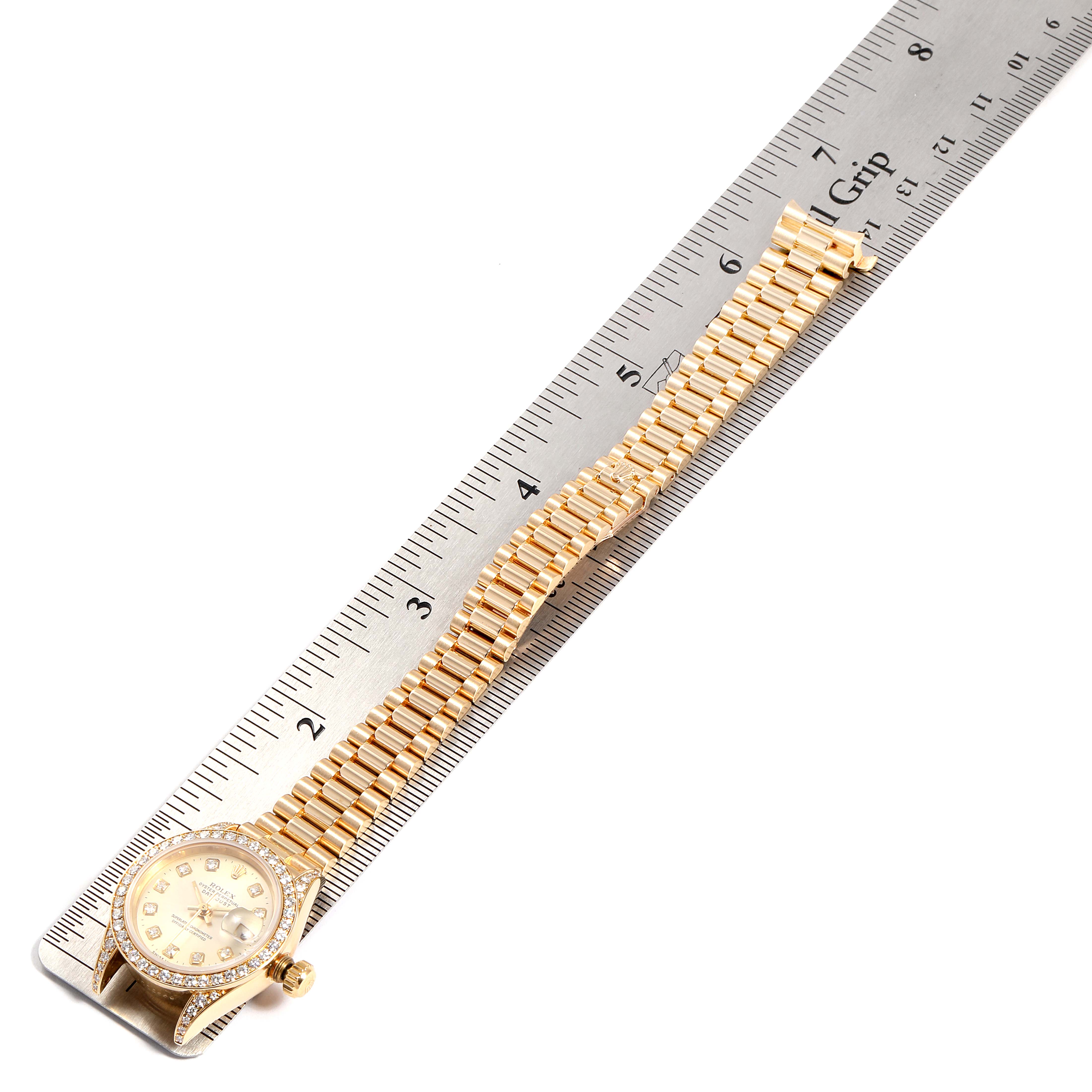 The image shows a Rolex President 69238 Women's Yellow Gold Silver Dial 69238 Women's Yellow Gold Silver Dial model watch placed alongside a ruler, highlighting the watch face and bracelet.