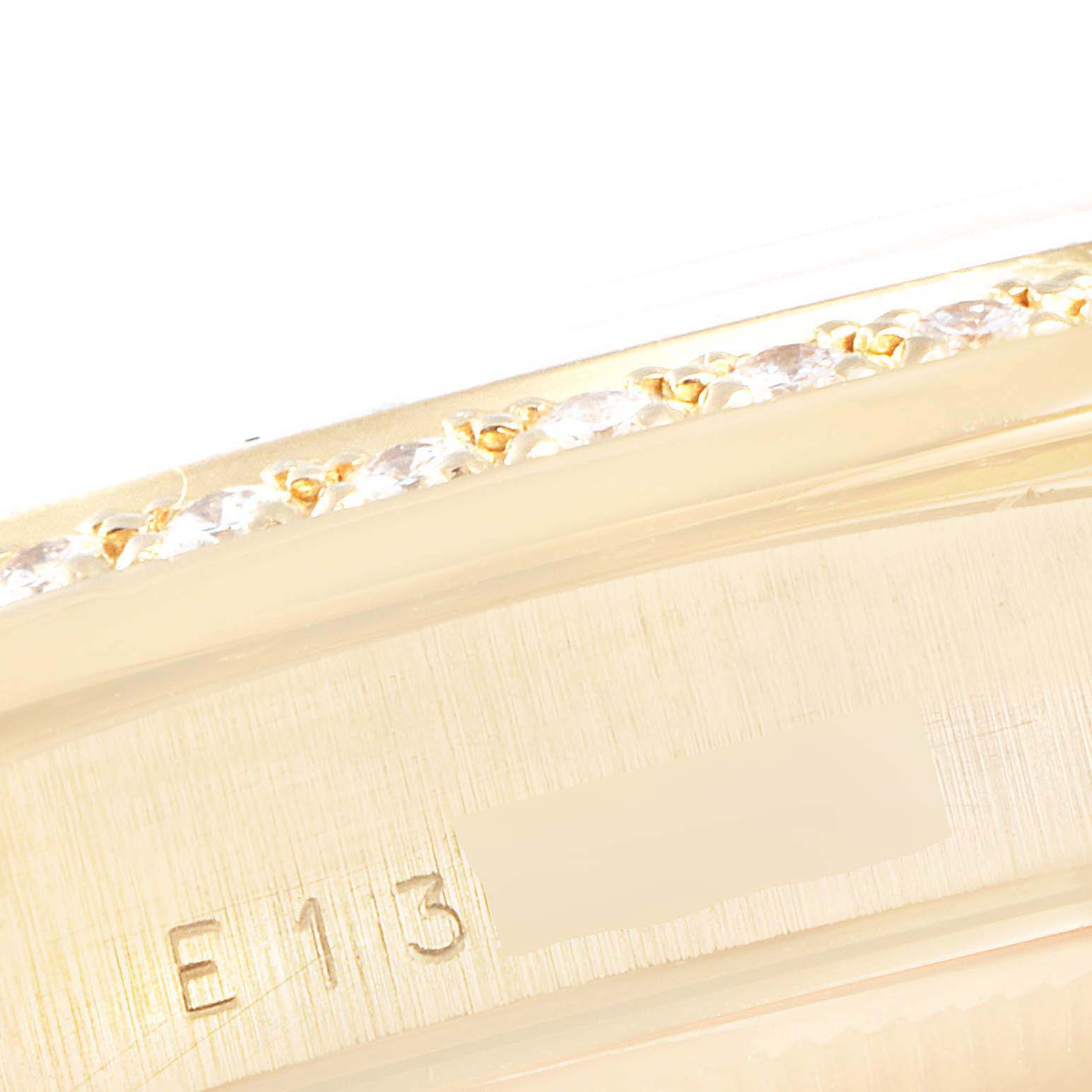 The image shows a close-up of the side of a Rolex President 18348 Men's Yellow Gold Champagne Dial 18348 Men's Yellow Gold Champagne Dial model watch, highlighting the bezel and part of the serial number.