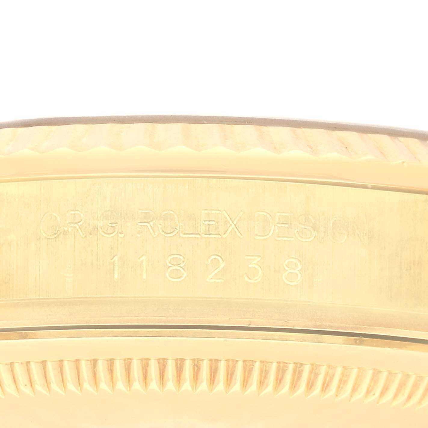 This image shows a close-up of the engraved case side of a Rolex President 118238 Men's Yellow Gold Black Dial 118238 Men's Yellow Gold Black Dial model watch.