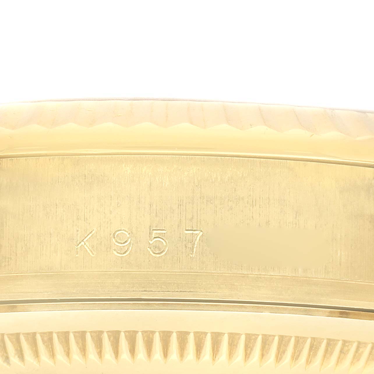 This image shows a close-up of the serial number engraving on the case back edge of a Rolex President 118238 Men's Yellow Gold Black Dial 118238 Men's Yellow Gold Black Dial model.