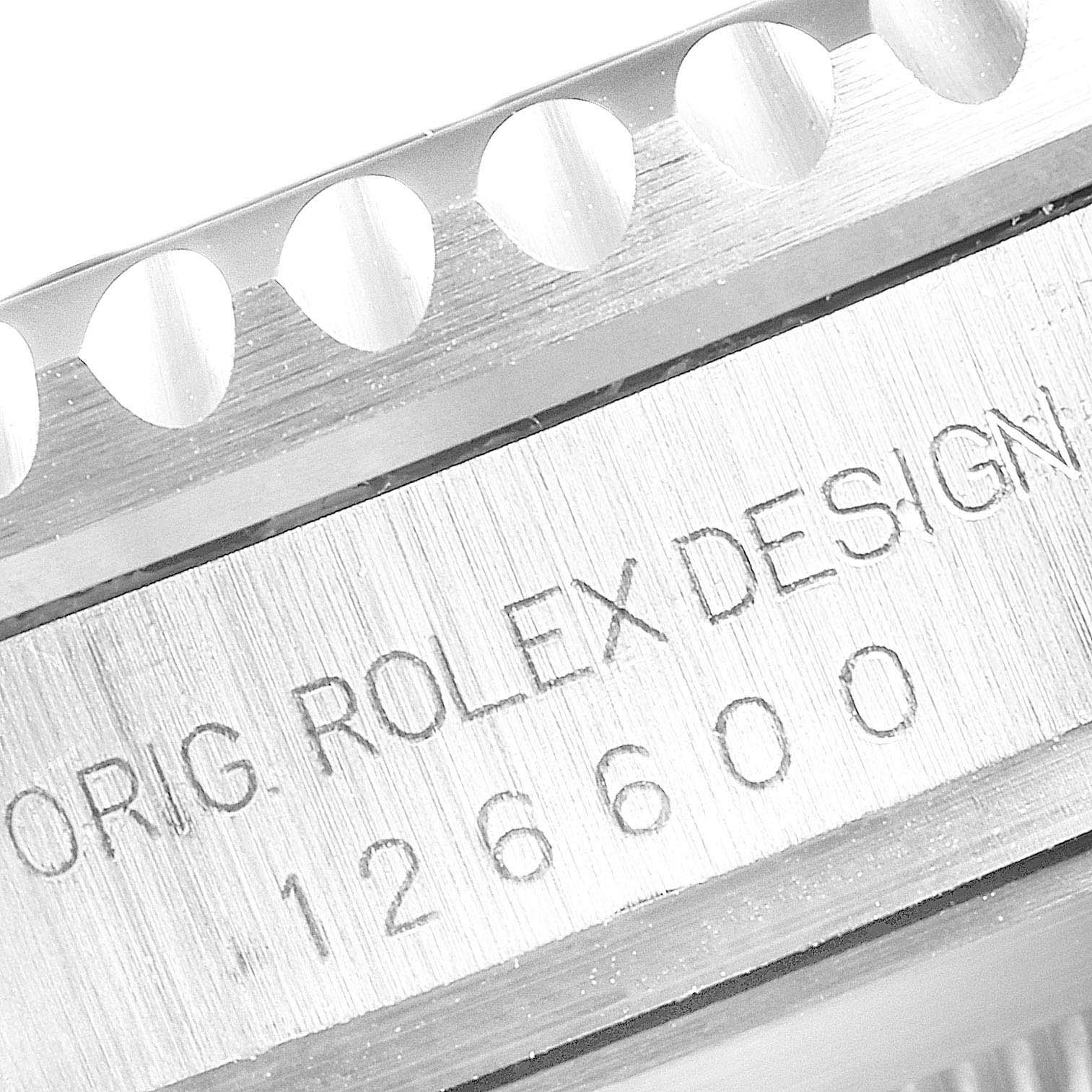 The image shows a close-up of a Rolex Sea-Dweller 126600 Men
s Stainless Steel Black Dial 126600 Men
s Stainless Steel Black Dial model, highlighting the engraved "ORIG. ROLEX DESIGN" and model number 126600.