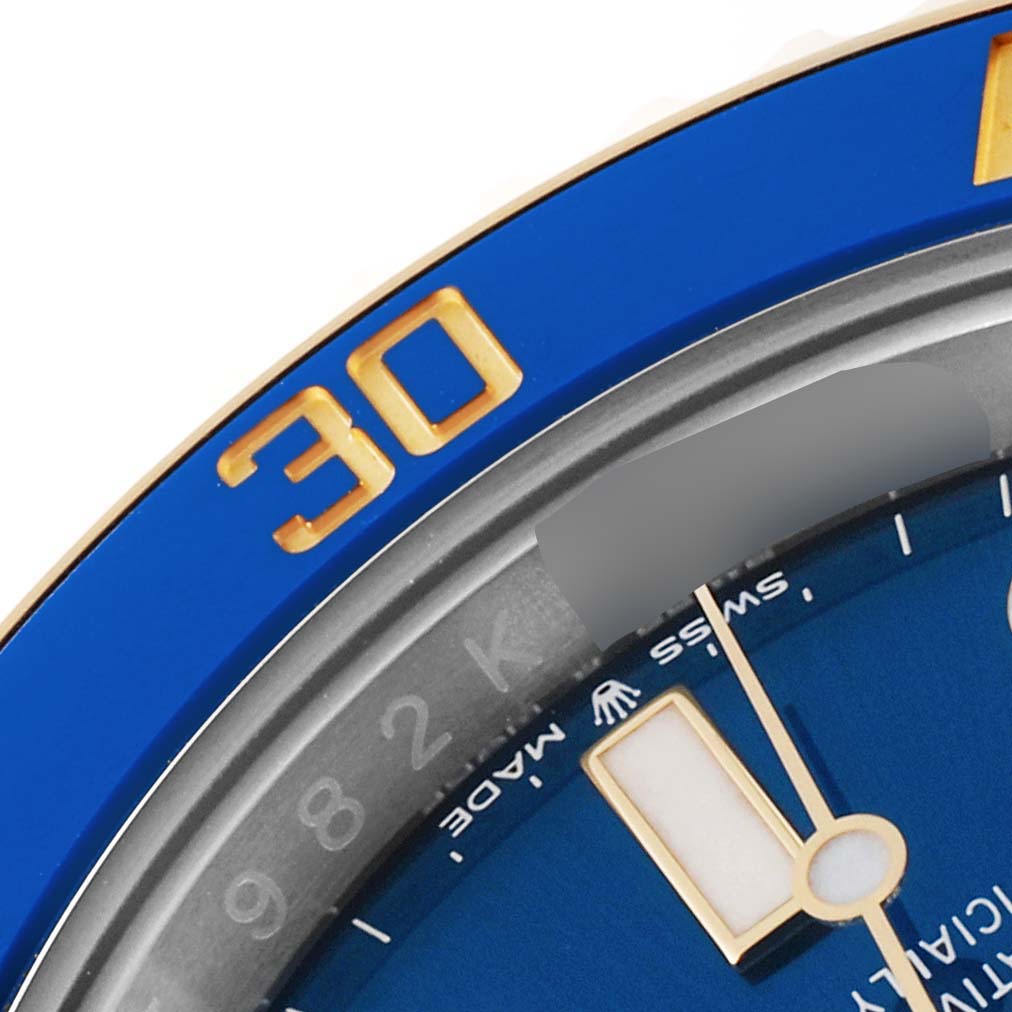 This image shows a close-up angled view of the bezel, dial, and minute hand of the Rolex Submariner 126613LB Men's Steel and Gold (two tone) Blue Dial 126613LB Men's Steel and Gold (two tone) Blue Dial watch.