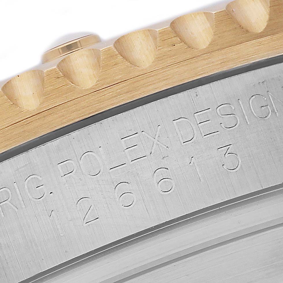 The image shows a close-up of the engraved side of the case and the bezel teeth of a Rolex Submariner 126613LB Men's Steel and Gold (two tone) Blue Dial 126613LB Men's Steel and Gold (two tone) Blue Dial.