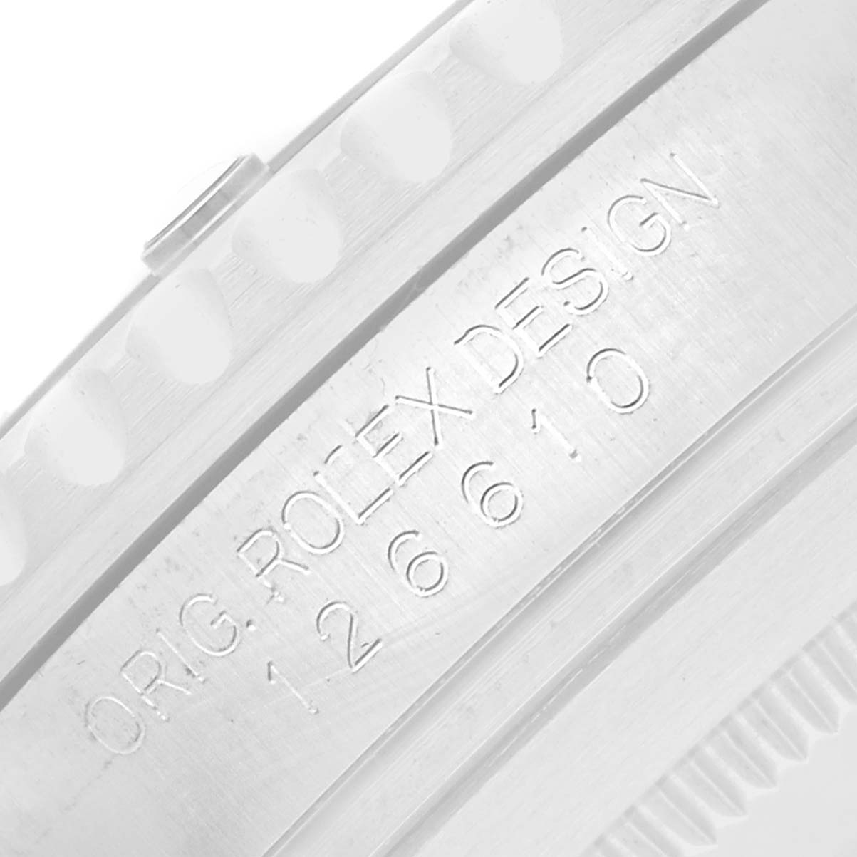 The image shows an angled close-up of the engraved side of a Rolex Submariner 126610 Men
s Stainless Steel Black Dial
s case, featuring the model number.