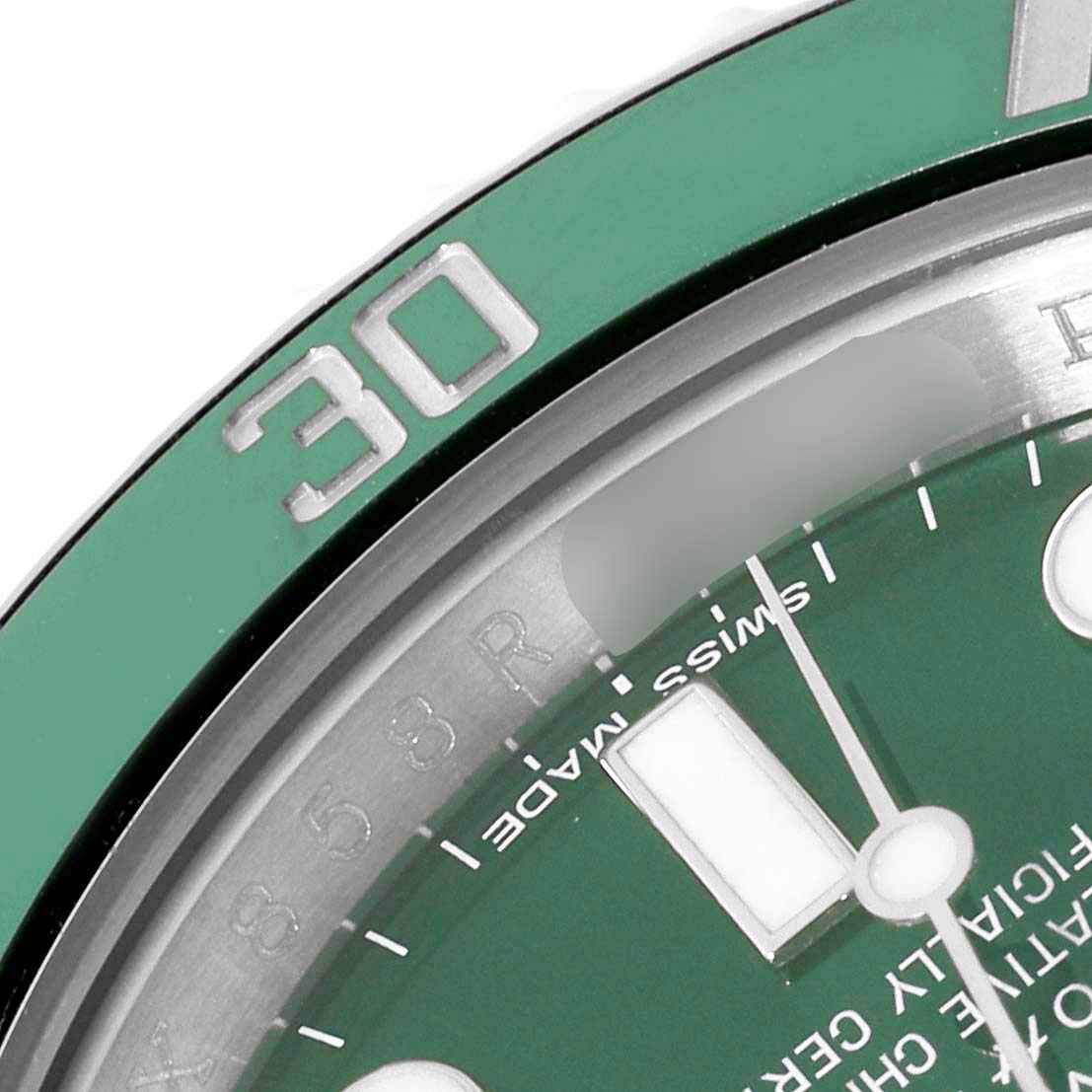 This close-up image shows the green bezel and a portion of the dial of a Rolex Submariner 116610LV Men's Stainless Steel Green Dial 116610LV Men's Stainless Steel Green Dial watch.