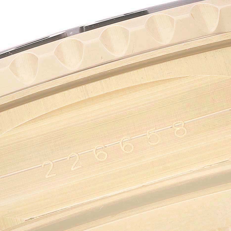 The image shows a close-up of the edge of a Rolex Yacht-Master 226658 Men's Yellow Gold Black Dial's bezel, highlighting its textured design.