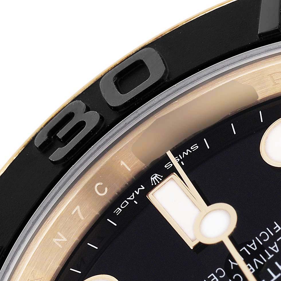 The image shows a close-up of the bezel and part of the dial of a Rolex Yacht-Master 226658 Men's Yellow Gold Black Dial watch.