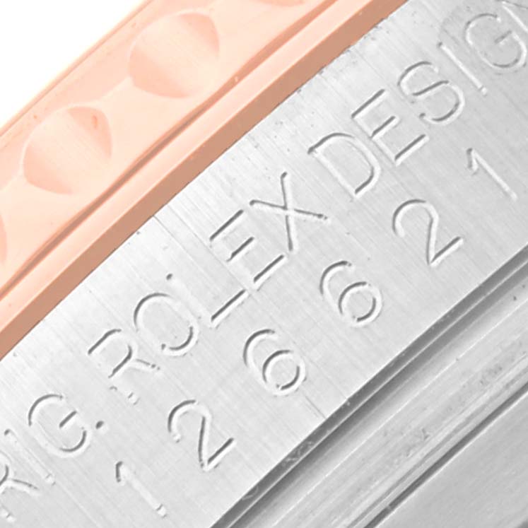 The image shows a close-up of the edge of the bezel and the case of Rolex Yacht-Master 126621 Men's Steel and Gold (two tone) Brown Dial 126621 Men's Steel and Gold (two tone) Brown Dial watch with engraved text.