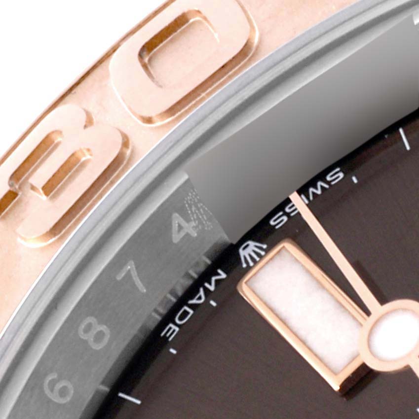 This close-up image of a Rolex Yacht-Master 126621 Men's Steel and Gold (two tone) Brown Dial 126621 Men's Steel and Gold (two tone) Brown Dial watch shows part of the bezel, dial, and hands.