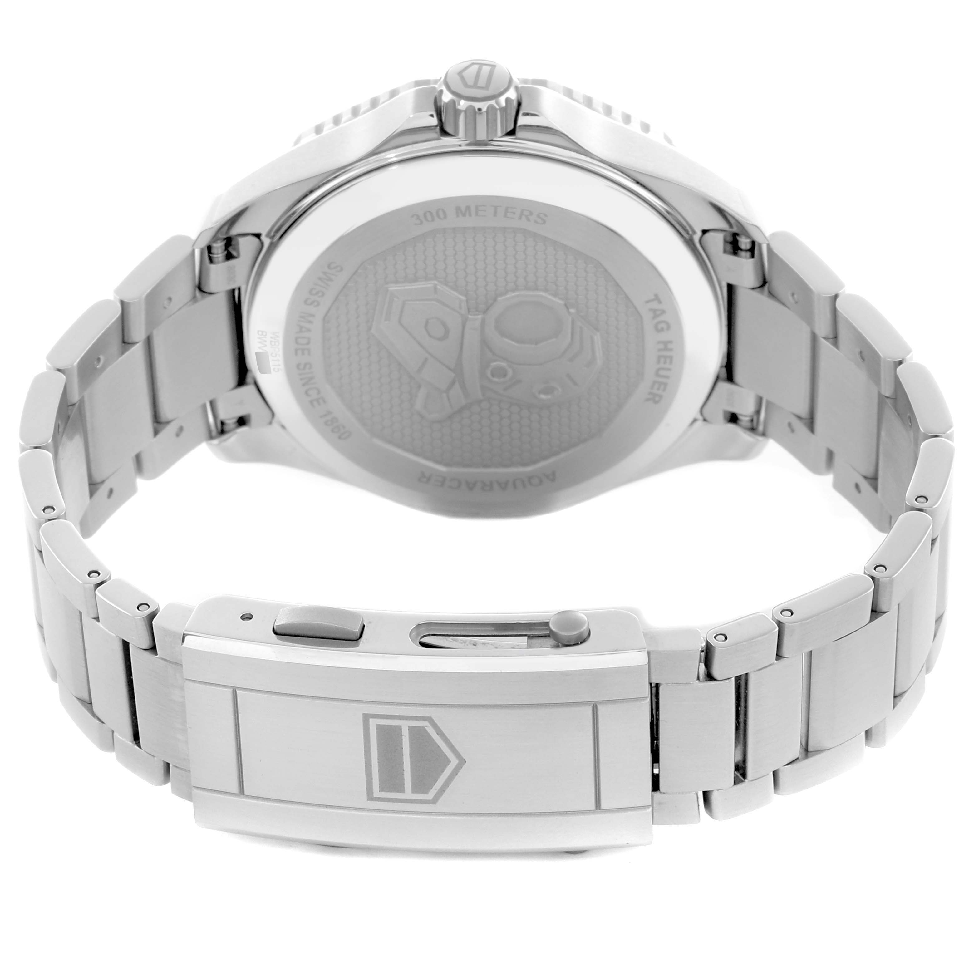 The image shows the back angle of a TAG Heuer Aquaracer watch, featuring its case back, crown, and metal bracelet clasp.
