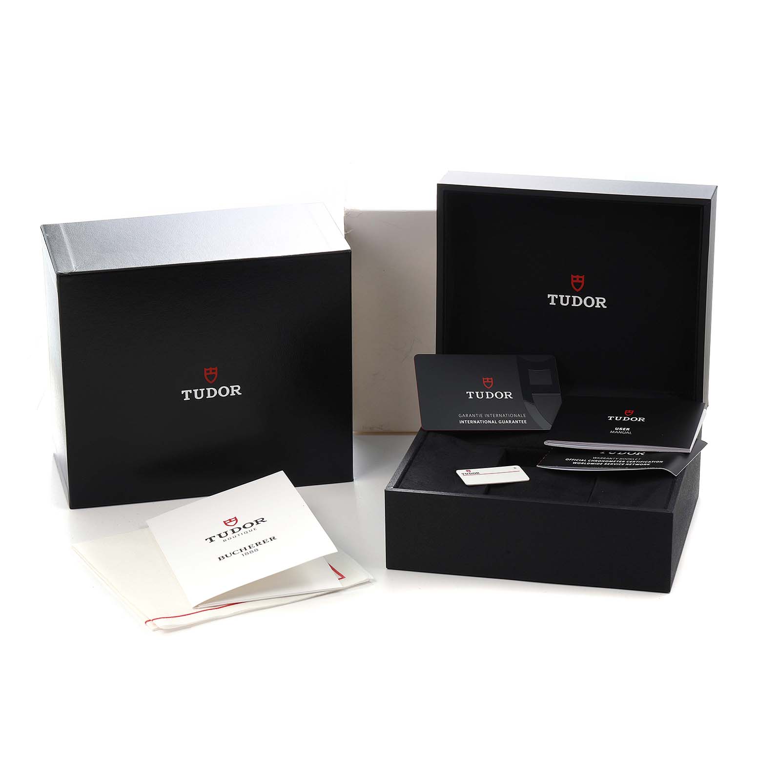 The image shows packaging and accessories for a Tudor Heritage Black Bay 79360 Men
s Stainless Steel Silver Dial watch, including boxes, manuals, and warranty cards.