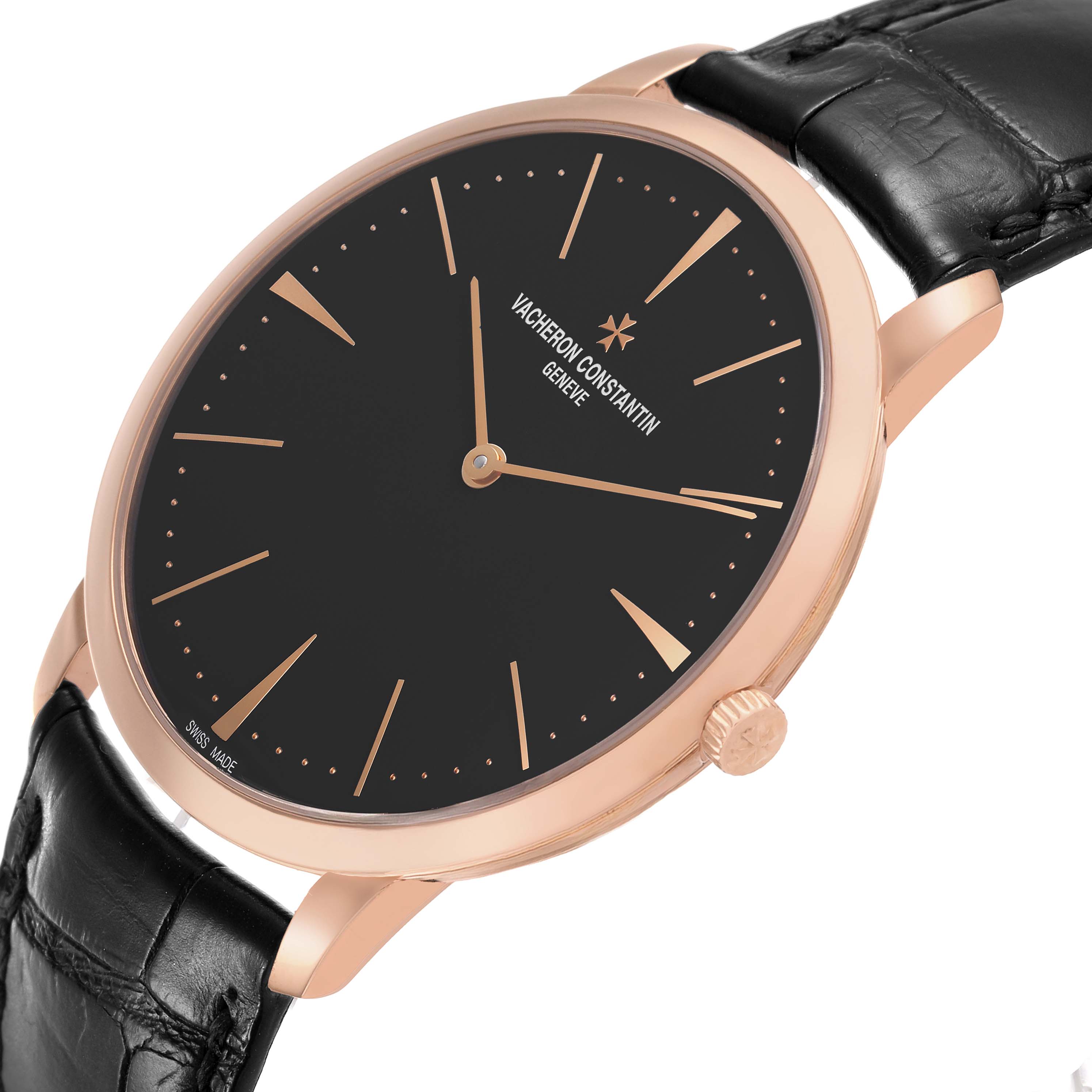 The Vacheron Constantin Patrimony 81180 Men's Rose Gold Grey Dial watch is shown at an angled side view, displaying its black dial, gold hands, and black leather strap.