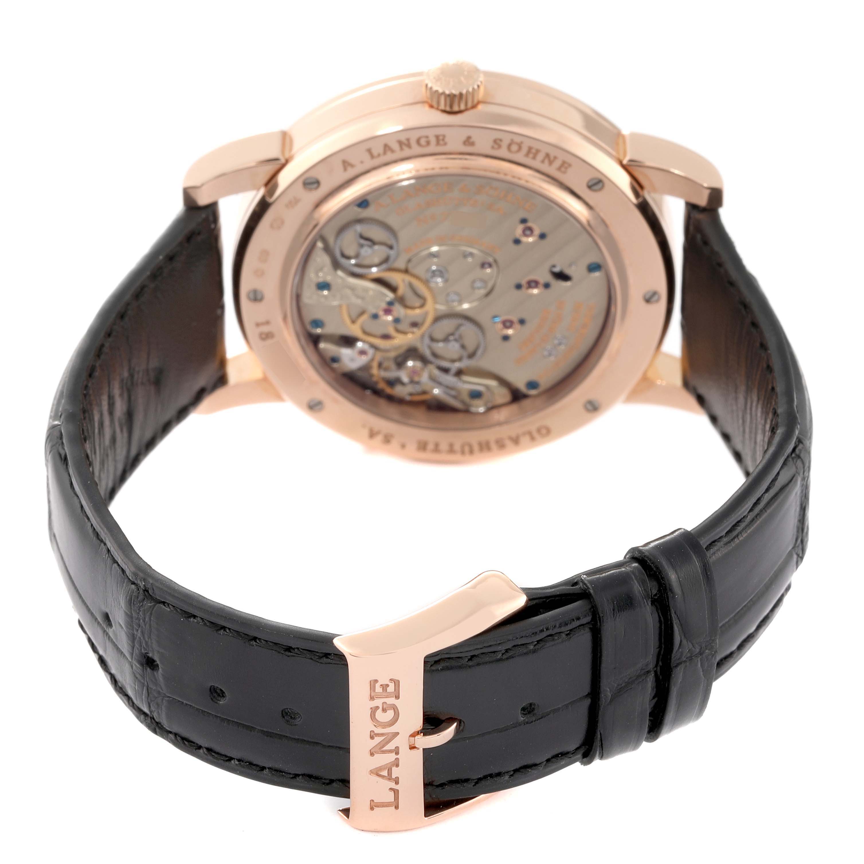 The image shows the back view of the A. Lange 
Sohne Lange 1 116.032 Men
s Rose Gold Silver Dial watch, highlighting the exposed movement and black leather strap.