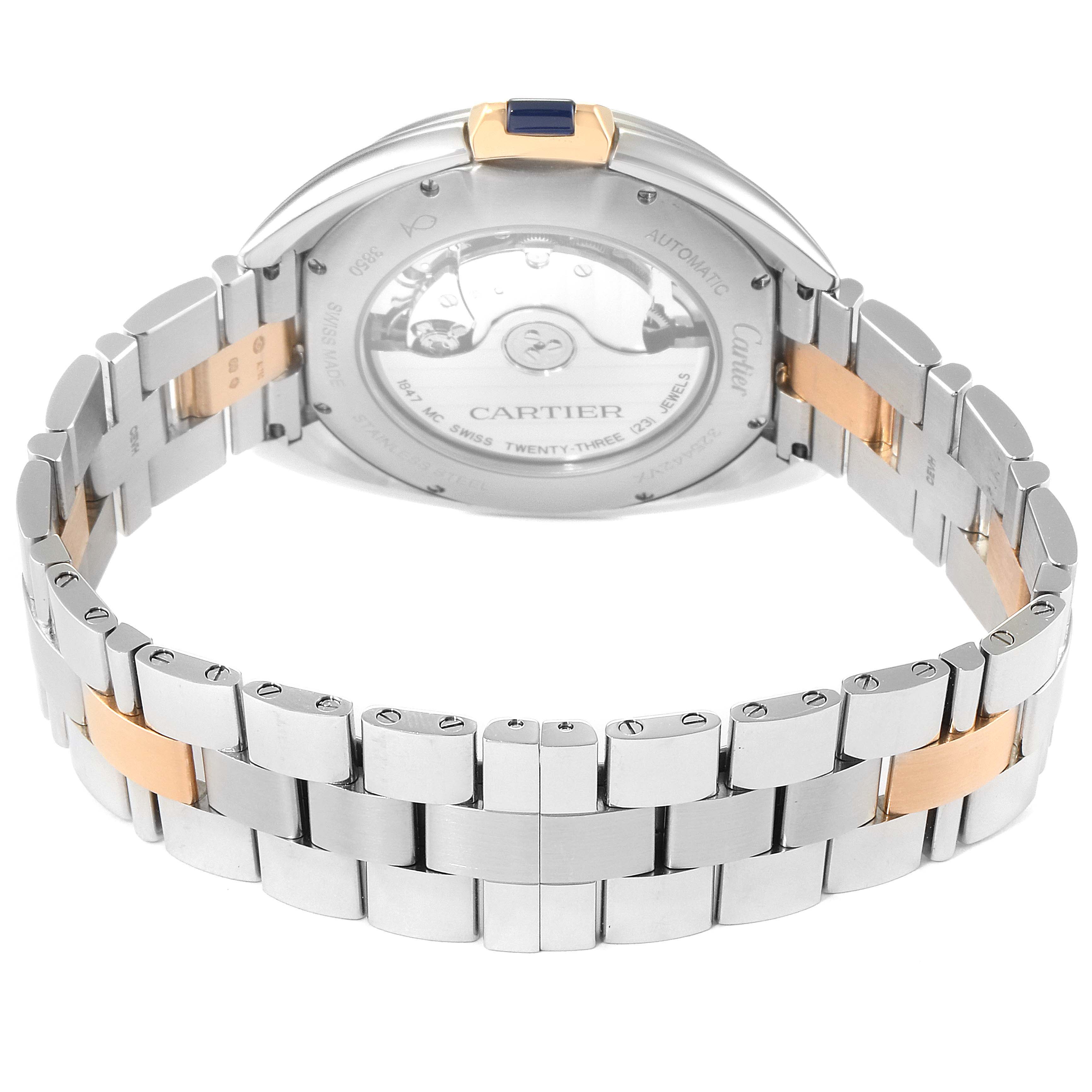 The image shows the back and bracelet of a Cartier Cle W2CL0002 Men's Steel and Gold (two tone) Silver Dial W2CL0002 Men's Steel and Gold (two tone) Silver Dial model watch, highlighting its automatic movement and two-tone metal design.