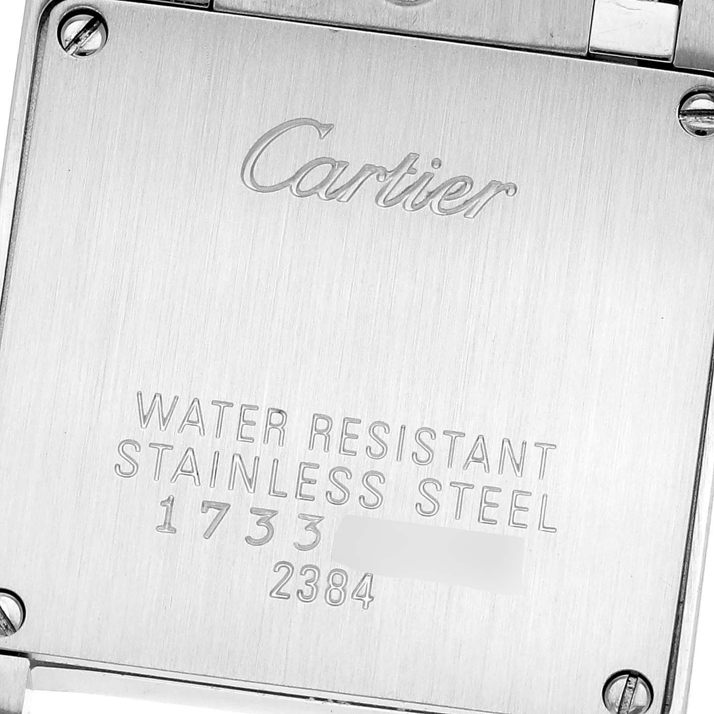 The image shows the engraved stainless steel back plate of the Cartier Tank Française watch.