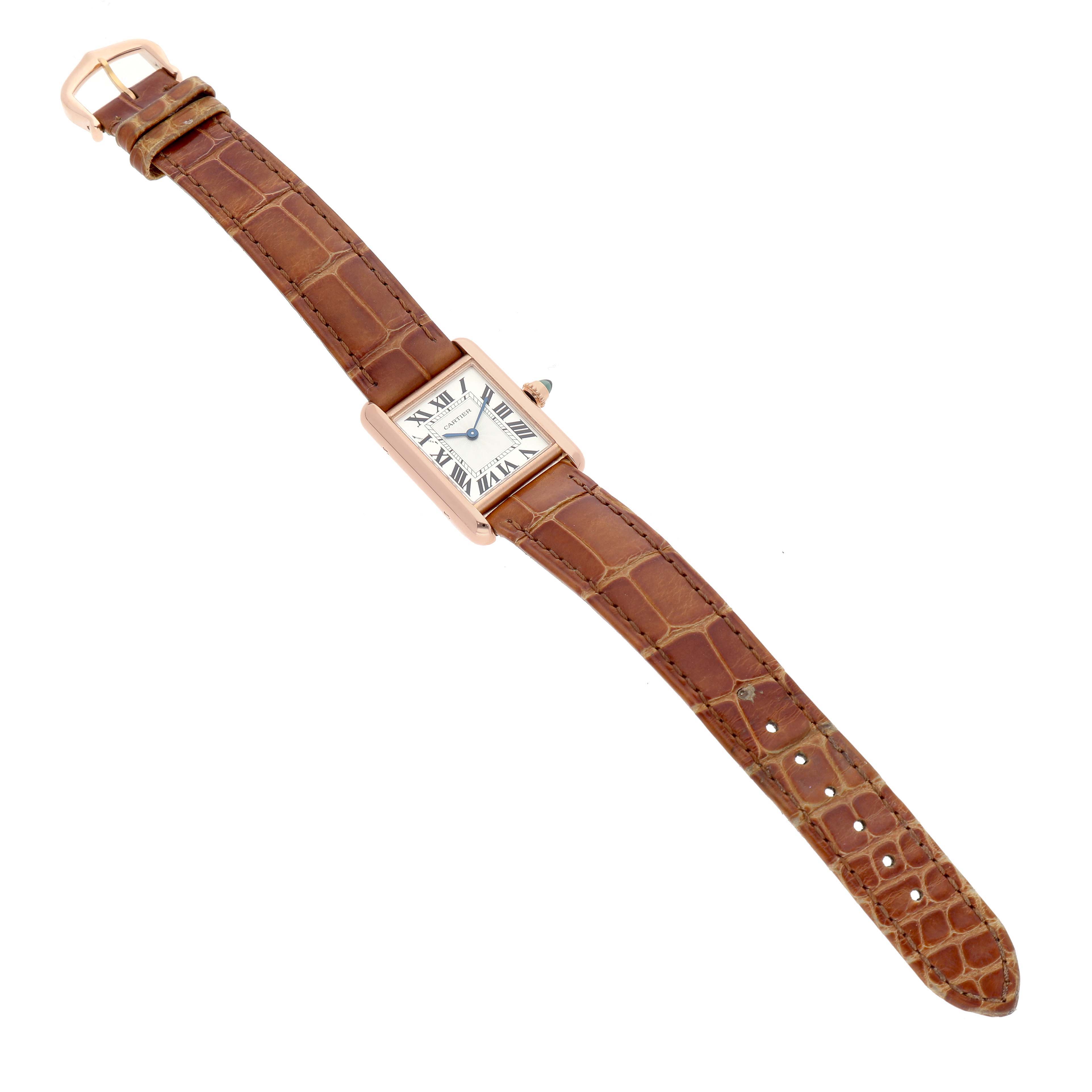 The Cartier Tank Louis WGTA0010 Women's Rose Gold Silver Dial watch is shown from a top-down angle, displaying its rectangular face and brown leather strap.