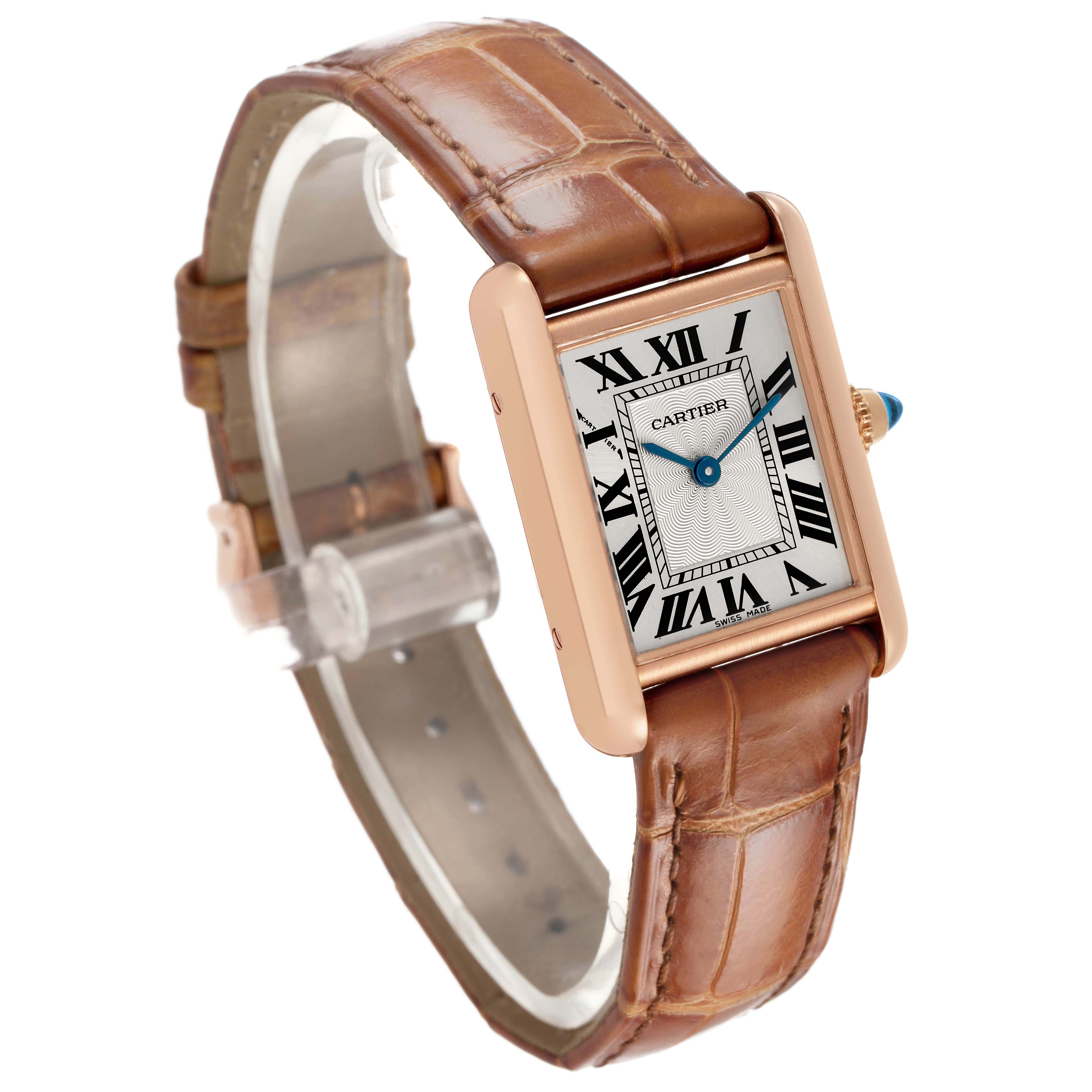 The Cartier Tank Louis WGTA0010 Women's Rose Gold Silver Dial watch is displayed at an angle showing the face, Roman numerals, blue hands, and brown leather strap.