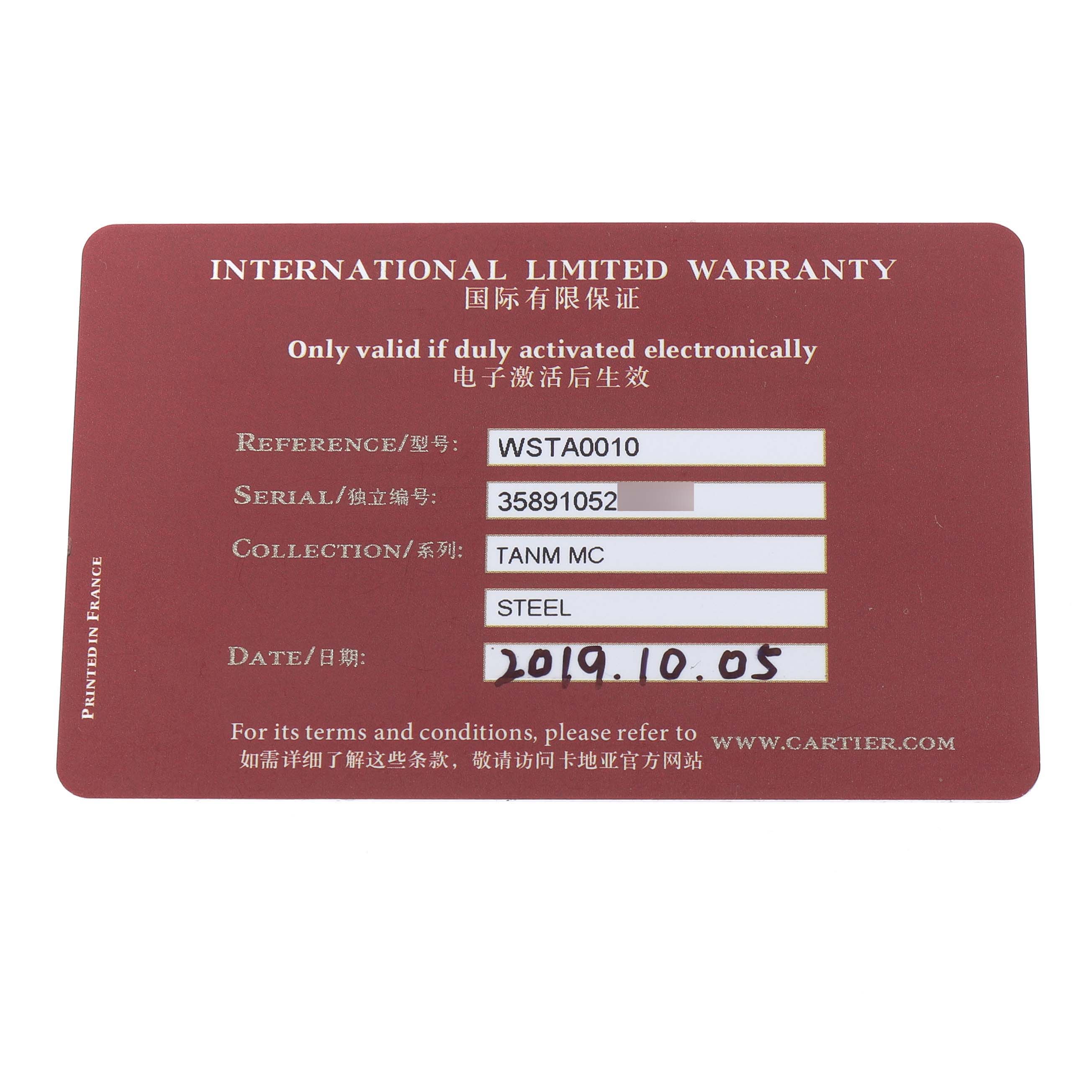 The image shows the international limited warranty card for a Cartier Tank MC WSTA0010 Men's Stainless Steel Blue Dial watch.