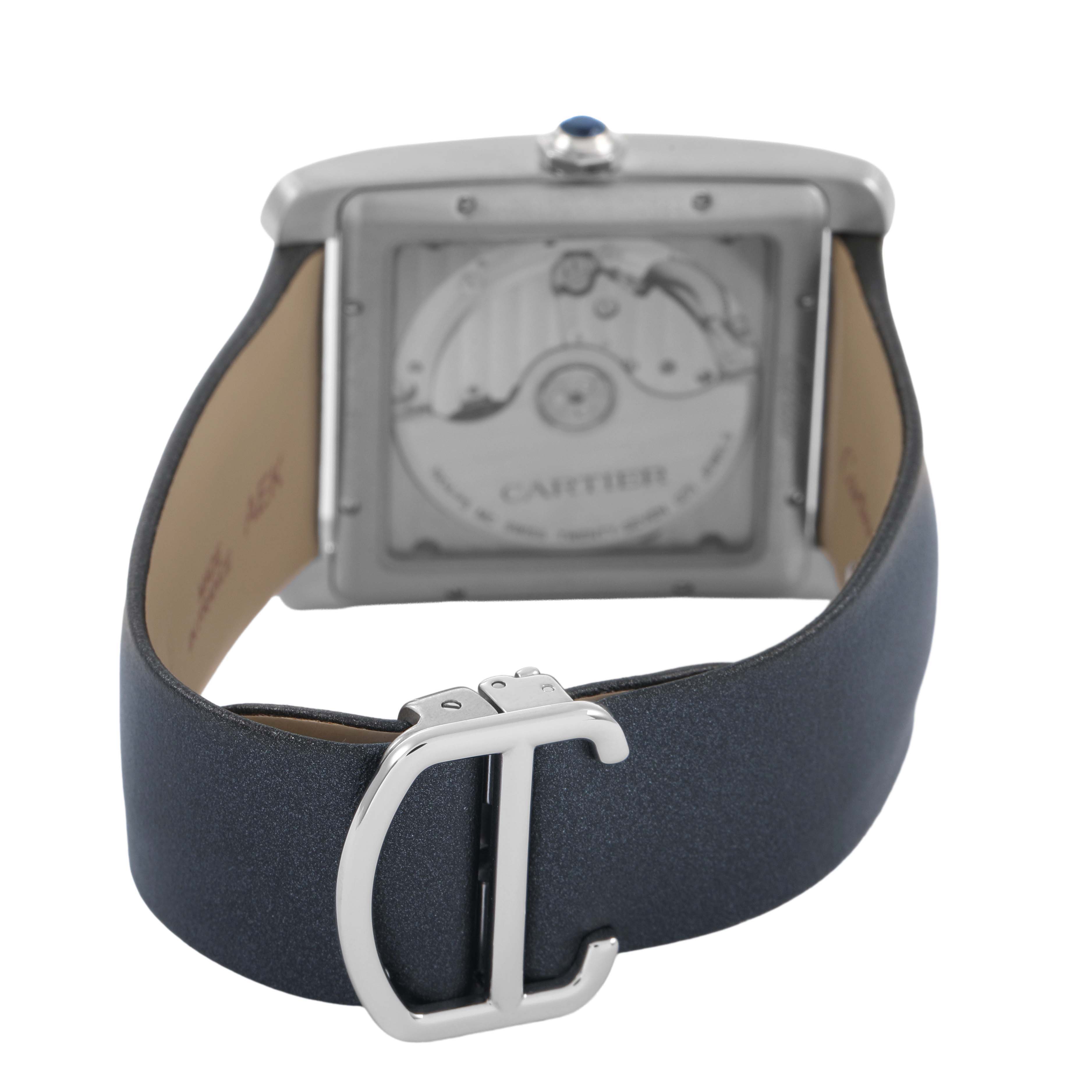 The Cartier Tank MC WSTA0010 Men's Stainless Steel Blue Dial watch is shown from the back, displaying the case back and leather strap with a clasp.