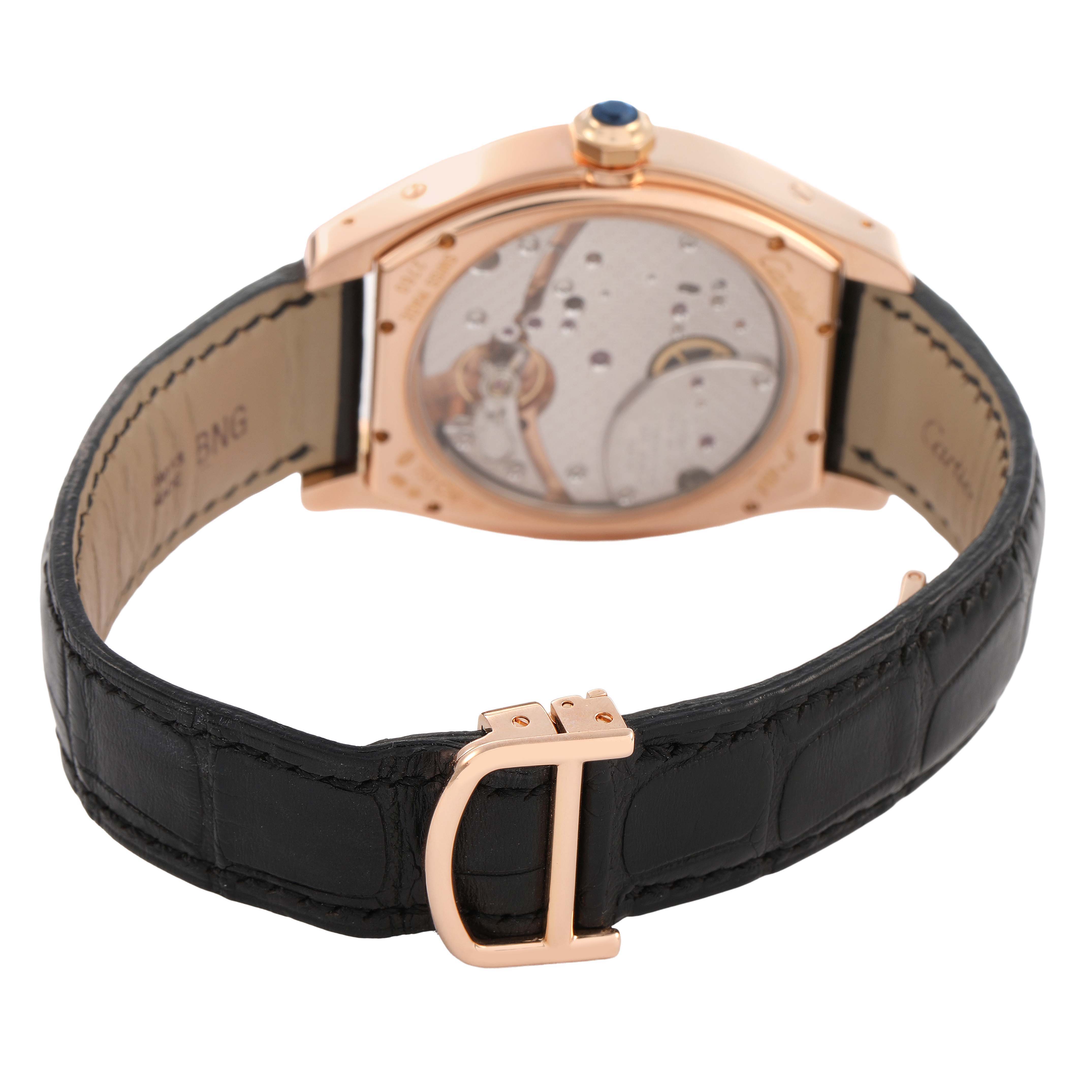 The Cartier Tortue W1545851 Men's Rose Gold Silver Dial watch is shown from the back, displaying its movement and the black leather strap with a rose gold buckle.