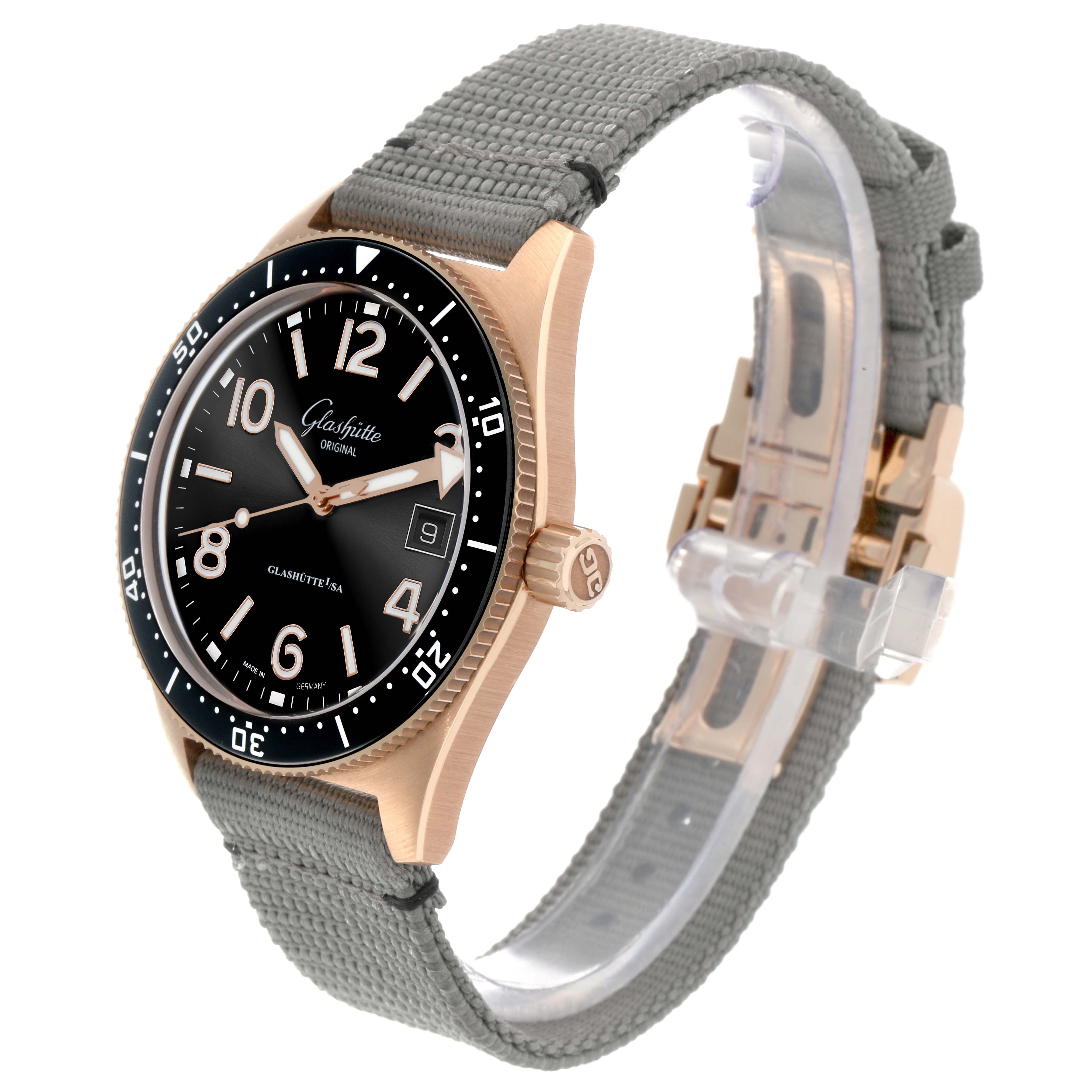 The Glashütte Original watch is shown at a three-quarter angle, displaying its rose gold case, black dial, and gray fabric strap.