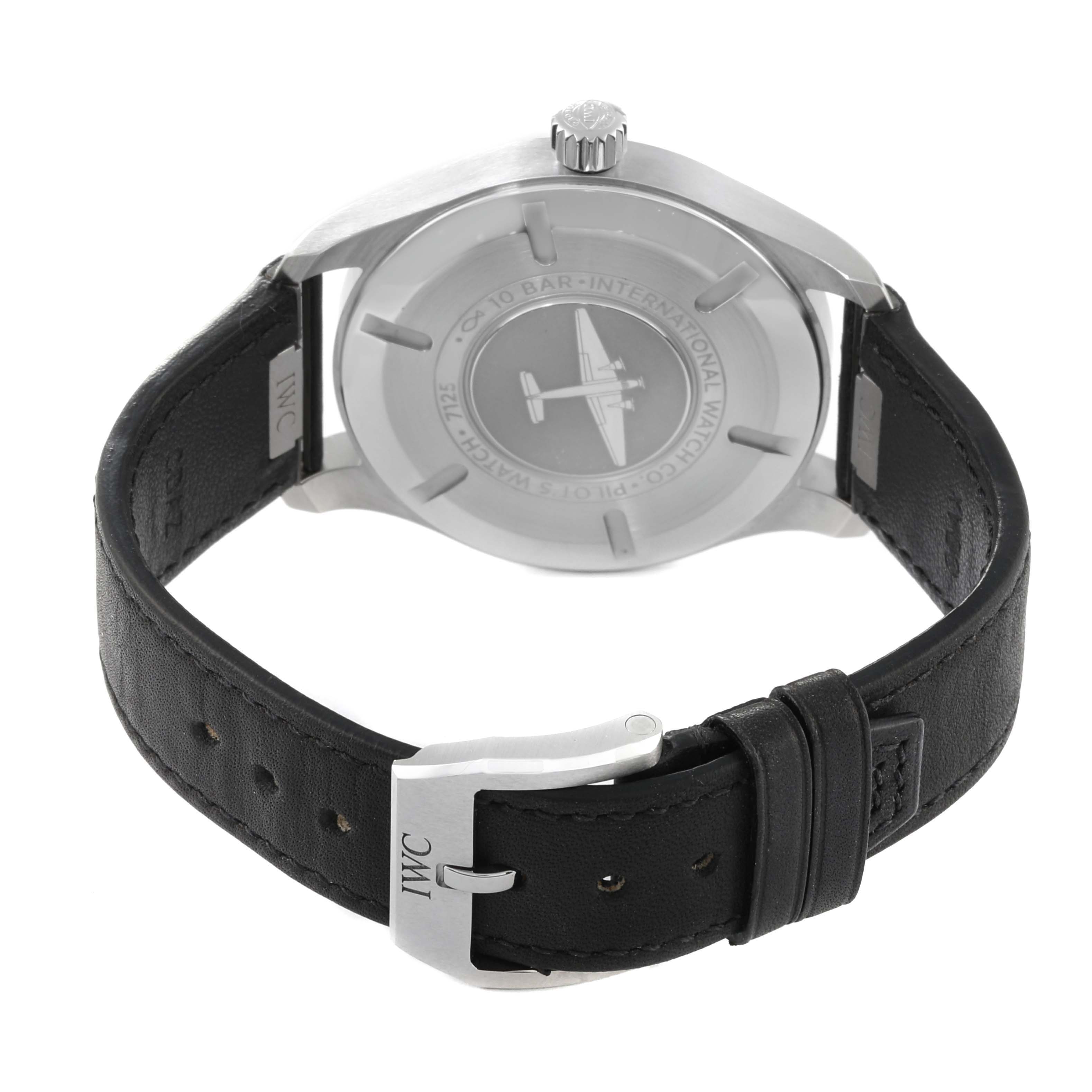 The watch is shown from the back, revealing the case back, crown, and black leather strap with an IWC-branded buckle.