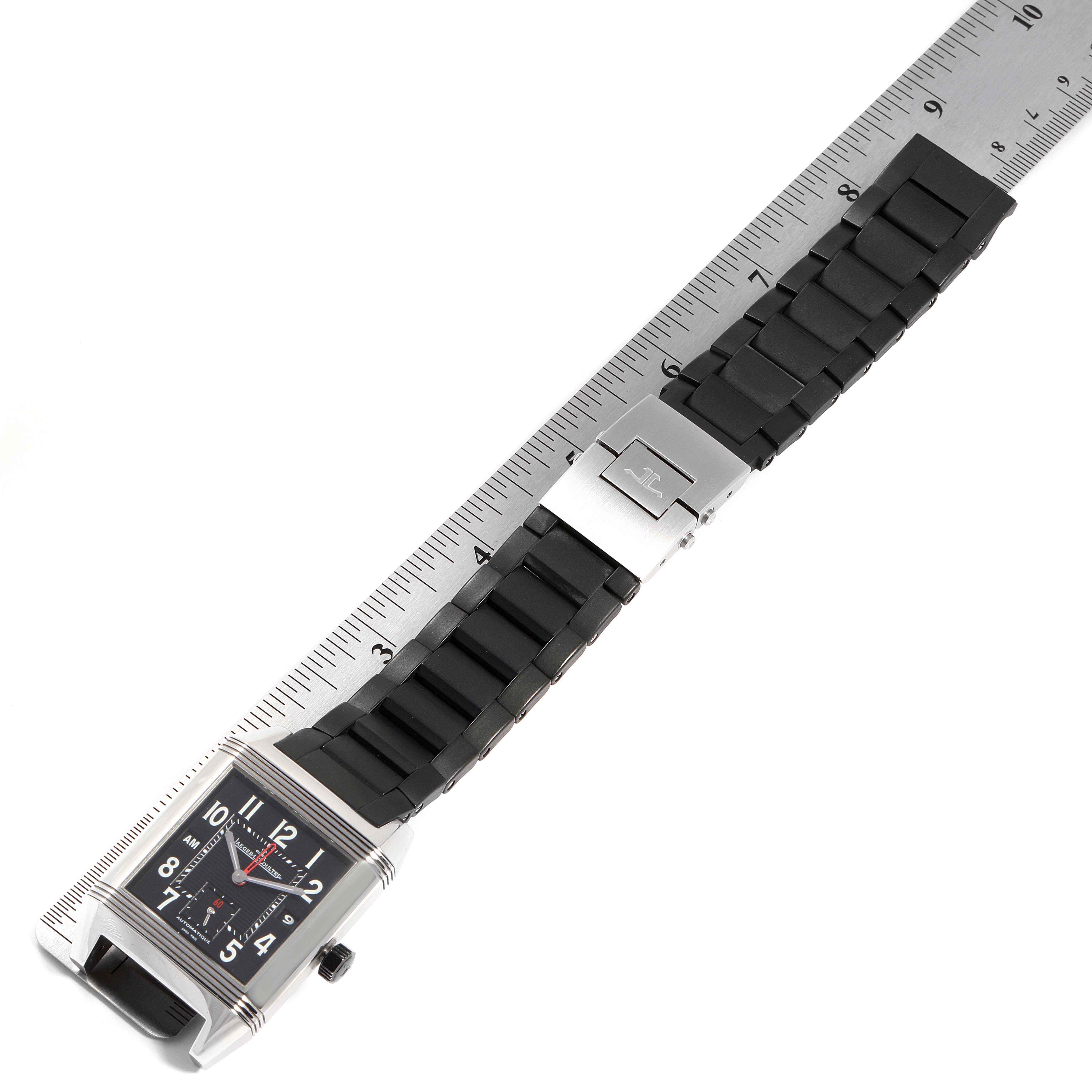 The image shows a Jaeger LeCoultre Reverso Q700867P Men's Stainless Steel Black Dial Q700867P Men's Stainless Steel Black Dial watch laid flat next to a ruler, highlighting the face, strap, and clasp.