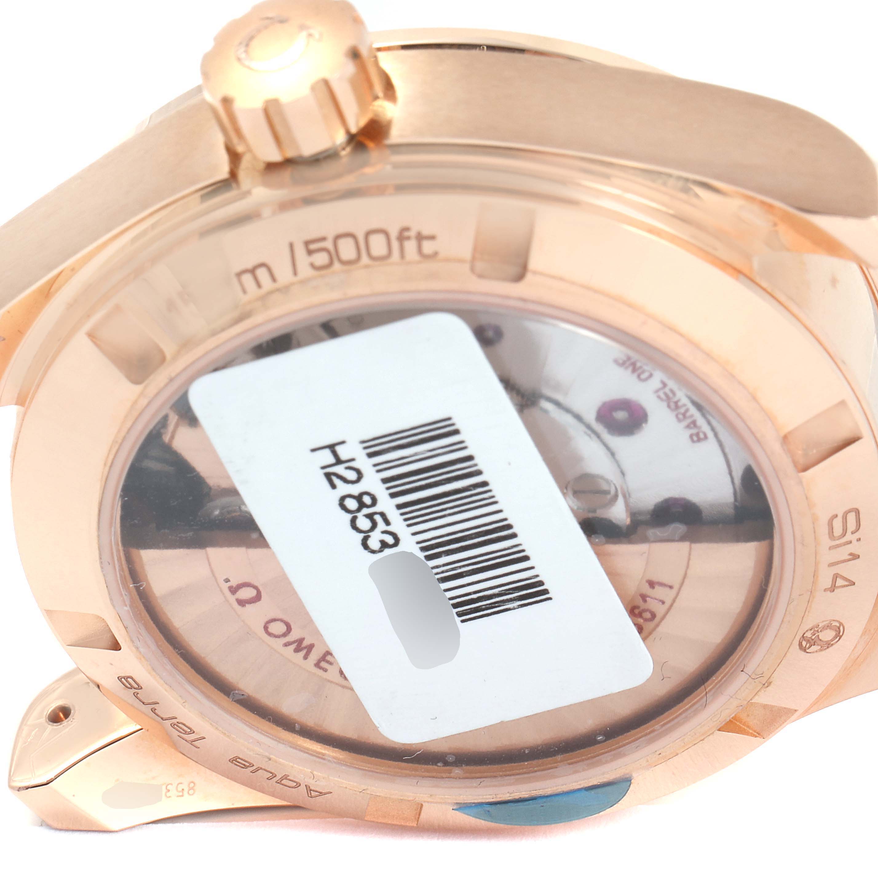 The image shows the backside of an Omega Aqua Terra 231.53.39.22.02.001 Men
s Rose Gold Silver Dial 231.53.39.22.02.001 Men
s Rose Gold Silver Dial watch, highlighting its case back and crown with a barcode sticker.