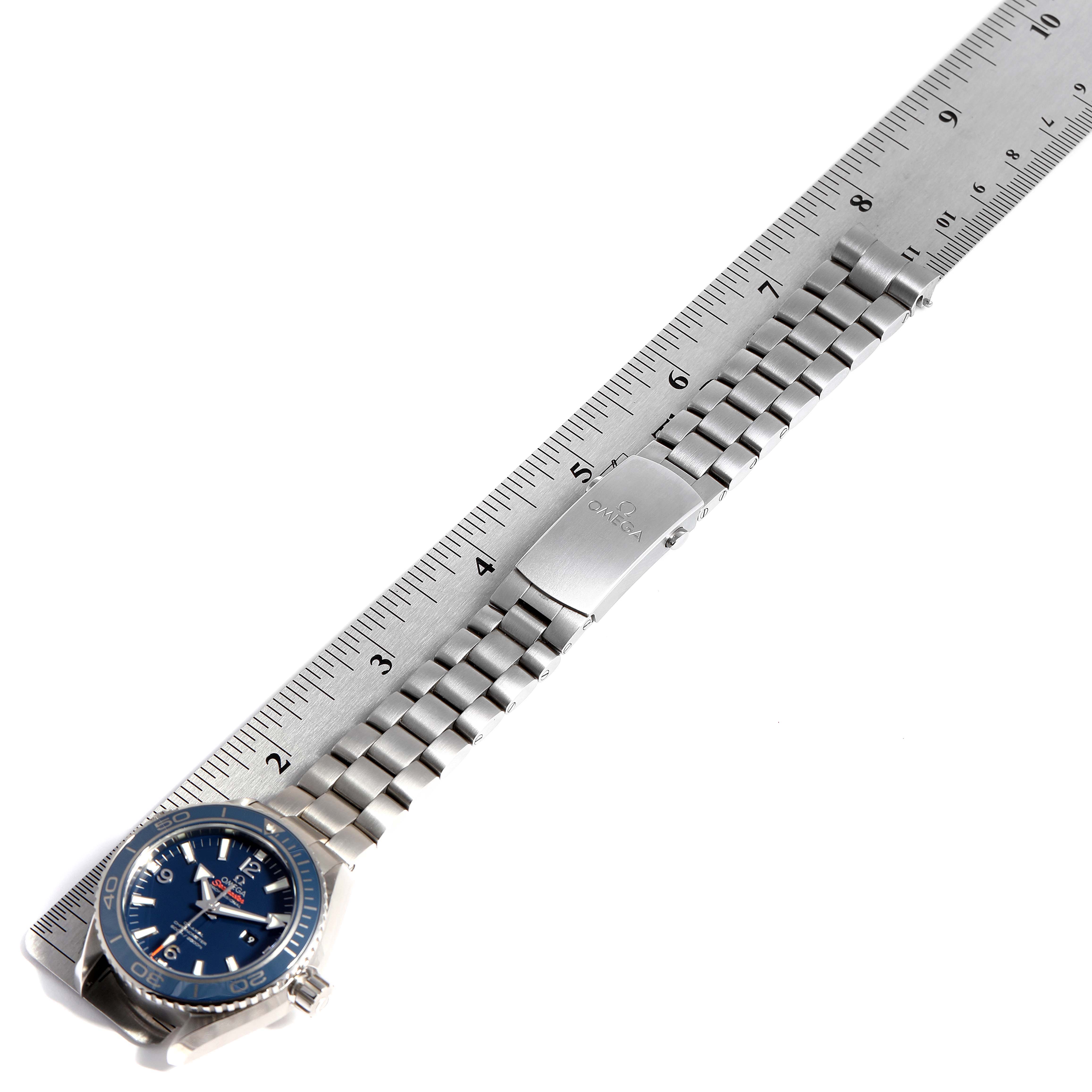 This image shows an Omega Seamaster 232.90.38.20.03.001 Men's Stainless Steel Blue Dial 232.90.38.20.03.001 Men's Stainless Steel Blue Dial watch placed alongside a ruler, displaying the watch face, bracelet, and clasp.