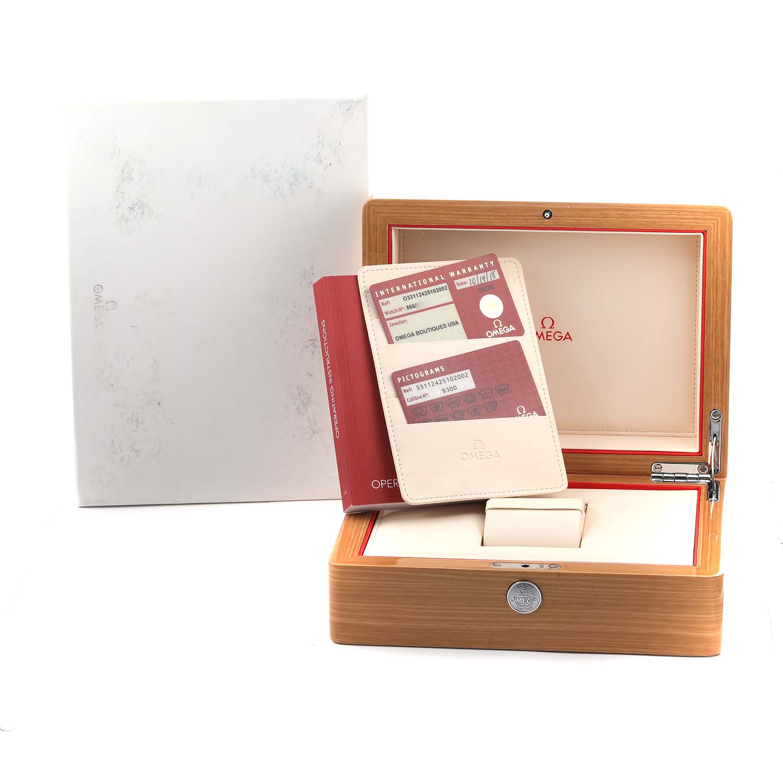The image shows an Omega Speedmaster 331.12.42.51.02.002 Men
s Stainless Steel Silver Dial watch box, warranty cards, and a booklet, all at a slightly elevated angle.